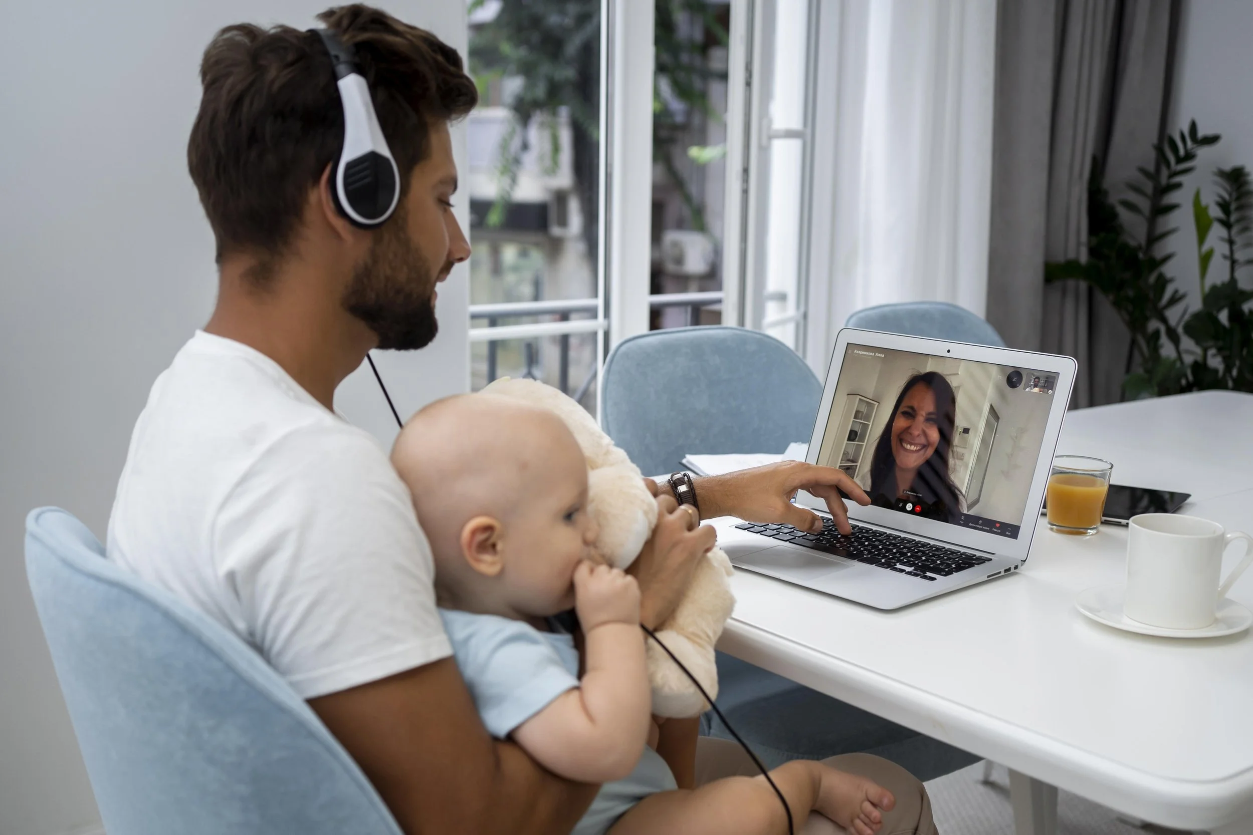 Parent receiving virtual coaching from speech therapist.