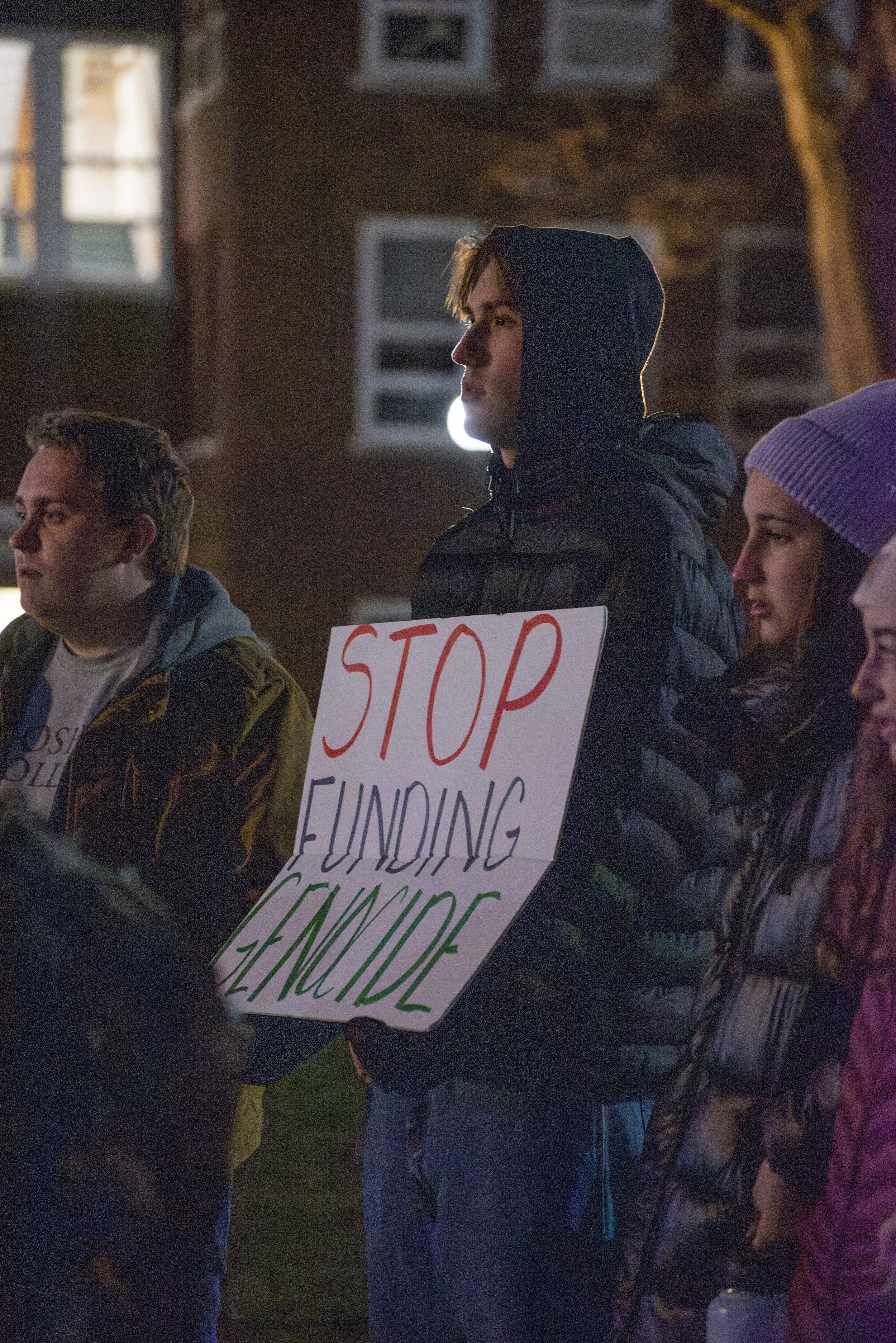 Ben Koop, a sophomore, holds a sign during an on campus protest last night.