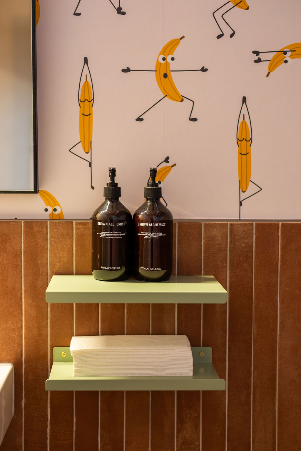 A bathroom with fun wallpaper and expensive hand soap