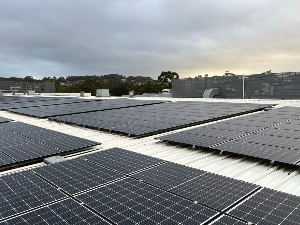Rooftop solar panels under cloudy sky