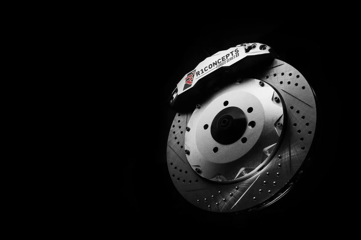 A high-performance disc brake rotor with a caliper labeled Ricochet Concepts, used for racing or sports cars.