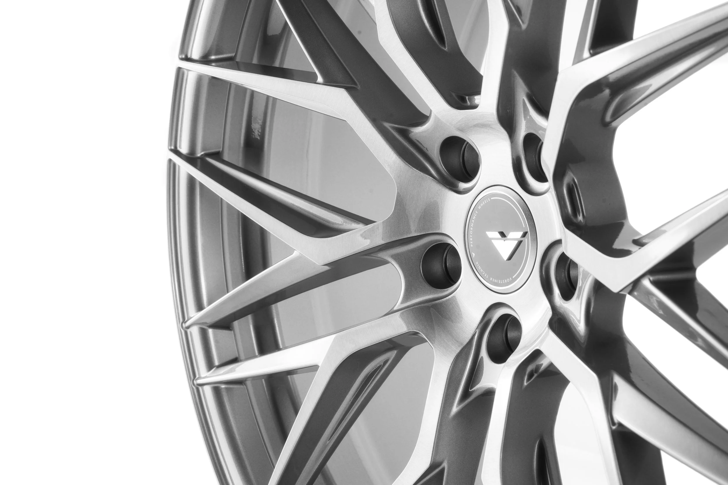 Close-up of a silver, multi-spoke car wheel with a central hub and lug nut holes, designed for high-performance vehicles.