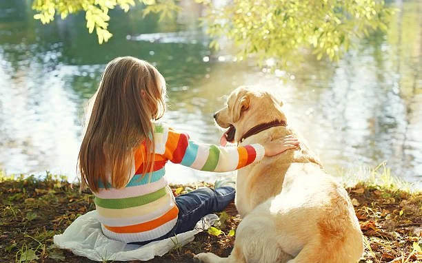 A young girl with her dog.