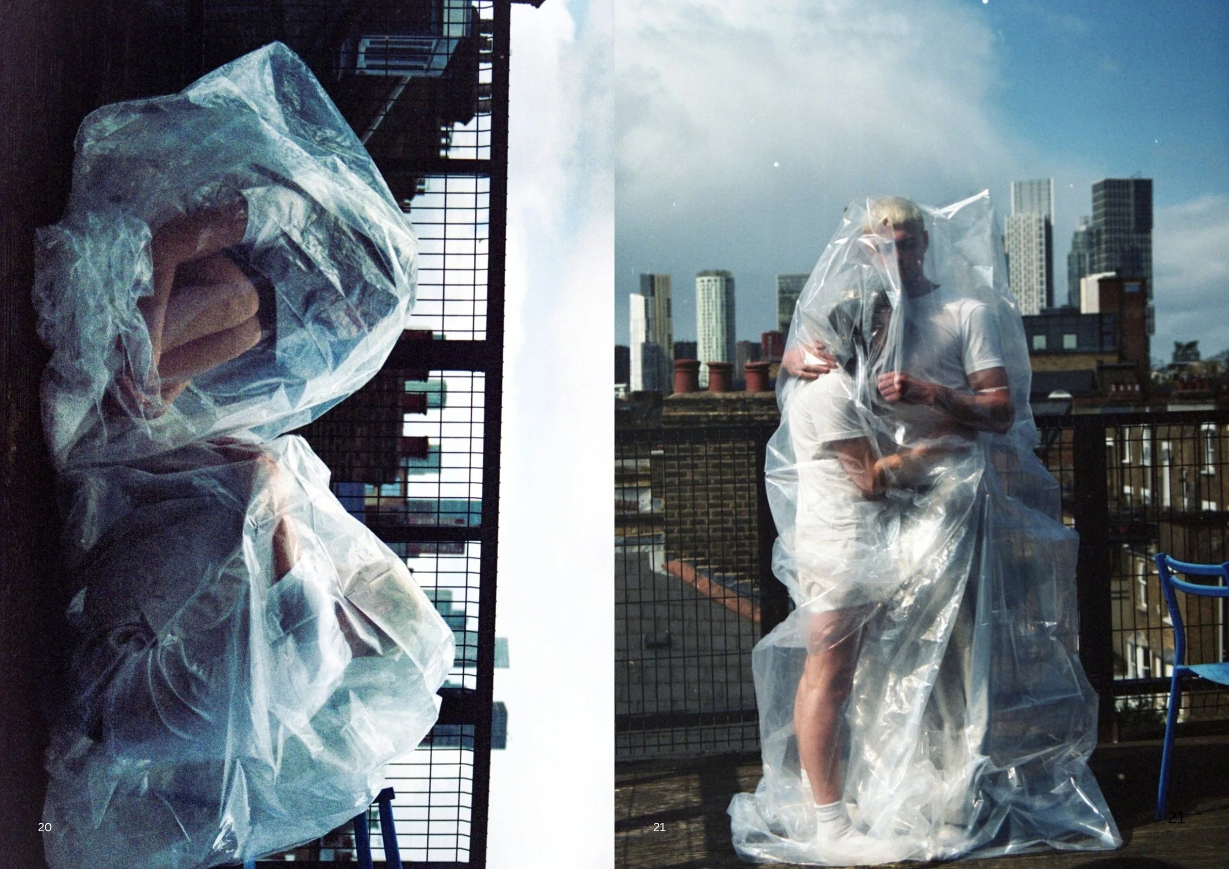 A person wearing a plastic poncho standing on a rooftop balcony with a city skyline in the background.
