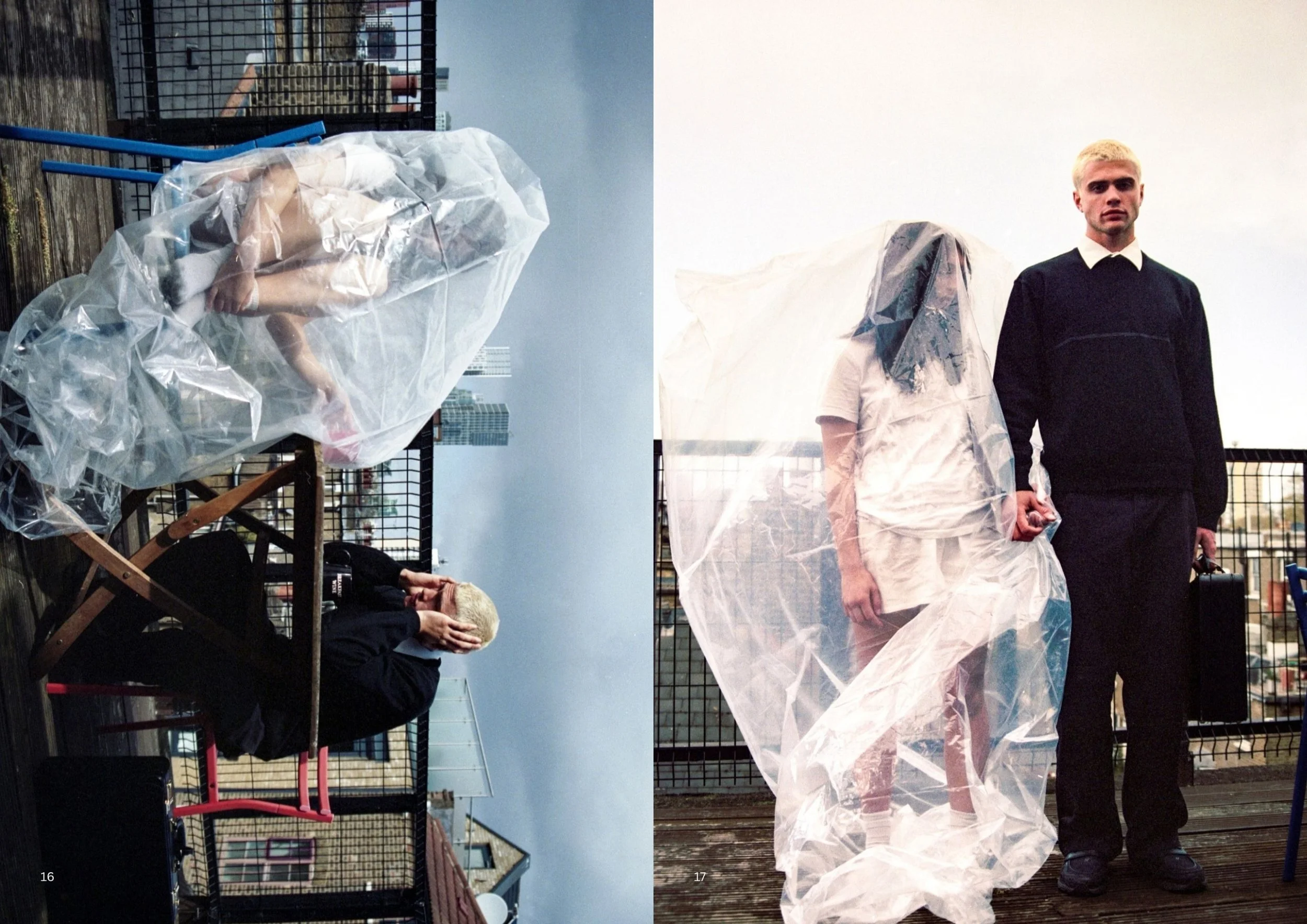 Two individuals on a rooftop, one sitting with their head in their hands and the other standing with blonde hair, dressed in black, with a third person in white with their head covered with a plastic bag, surrounded by fencing and urban buildings in 