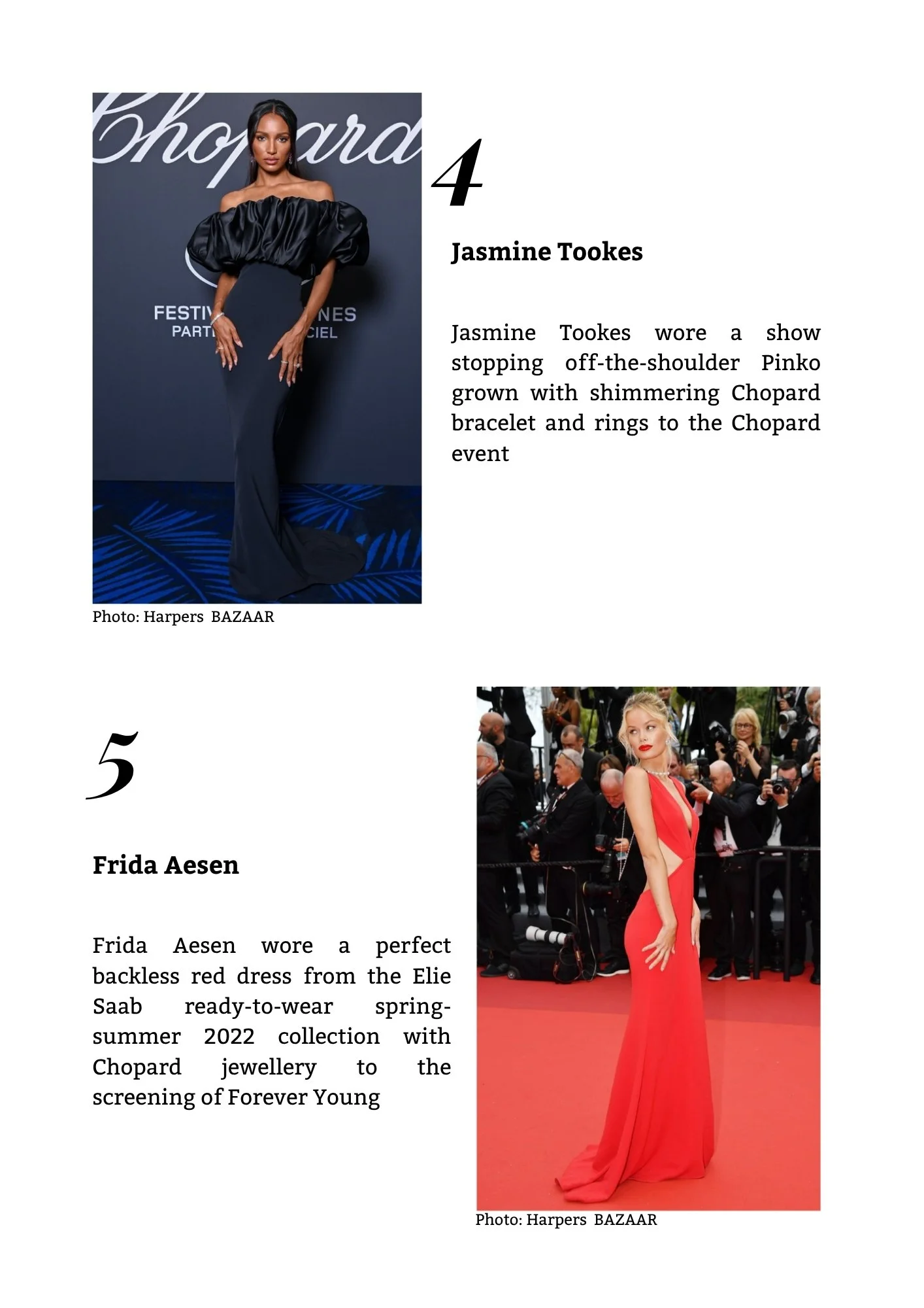 A woman dressed in a spectacular red gown walking down a red carpet at a formal event. She is surrounded by photographers and attendees, with a black backdrop and event branding visible behind her.