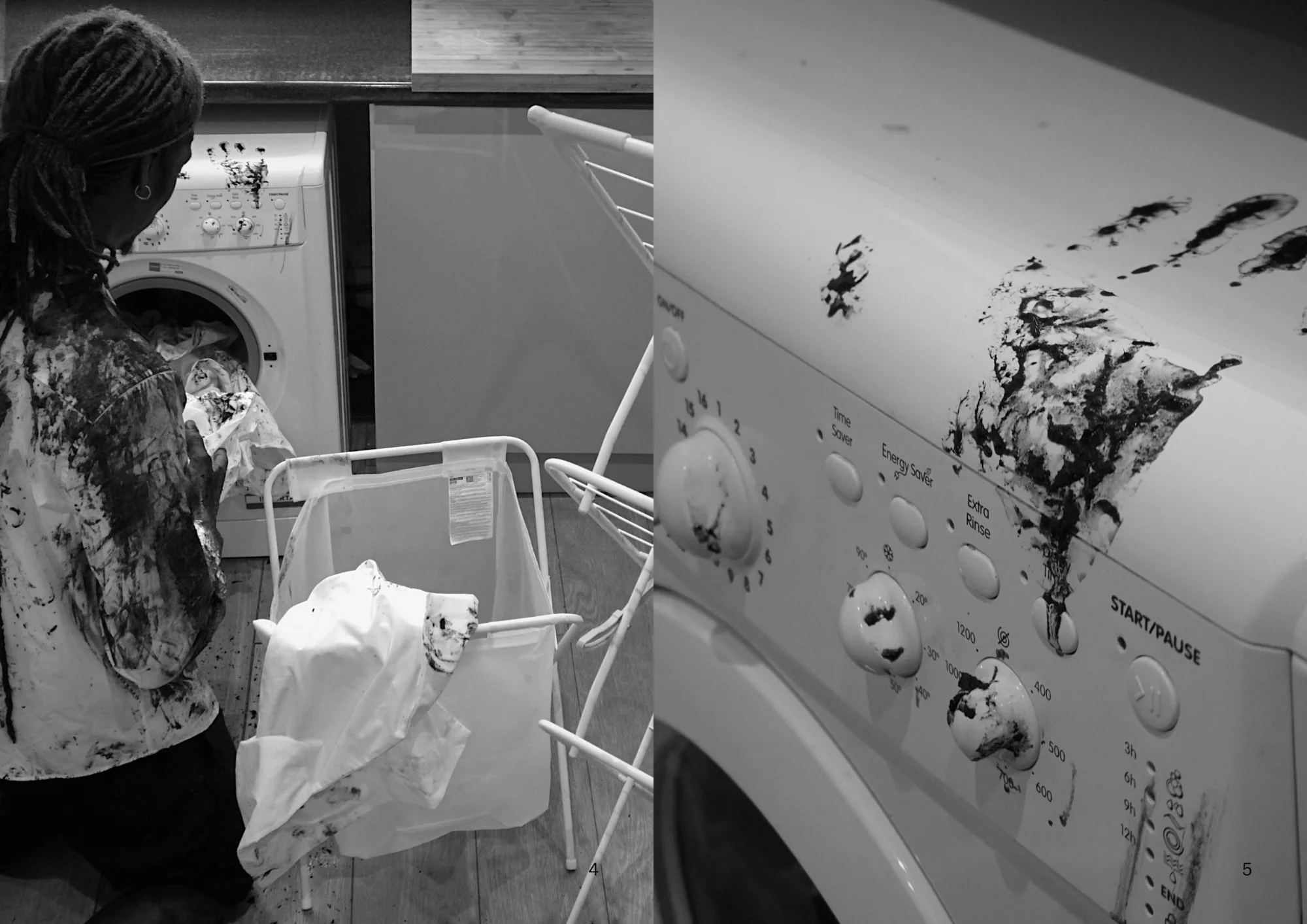 A person with dreadlocks wearing a paint-splattered shirt is doing laundry in a washing machine. The laundry basket is visible nearby. The right side of the image shows a washing machine with some black ink or paint stains on its surface.