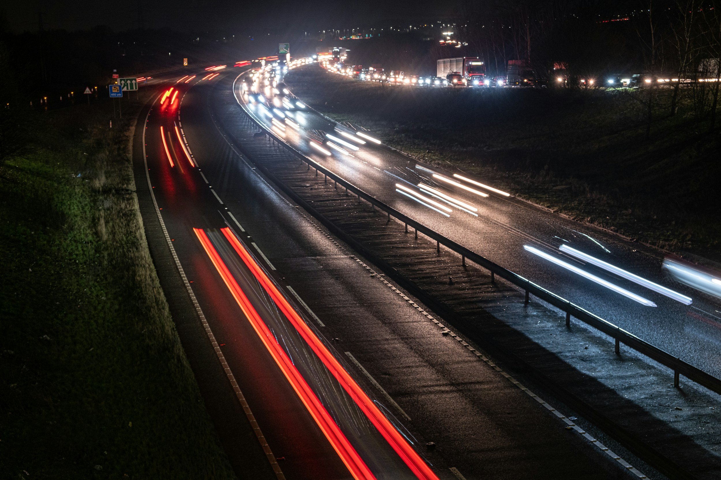Blurred motion of headlights illustrating how the nervous system responds to chronic pain triggers faster than conscious thought