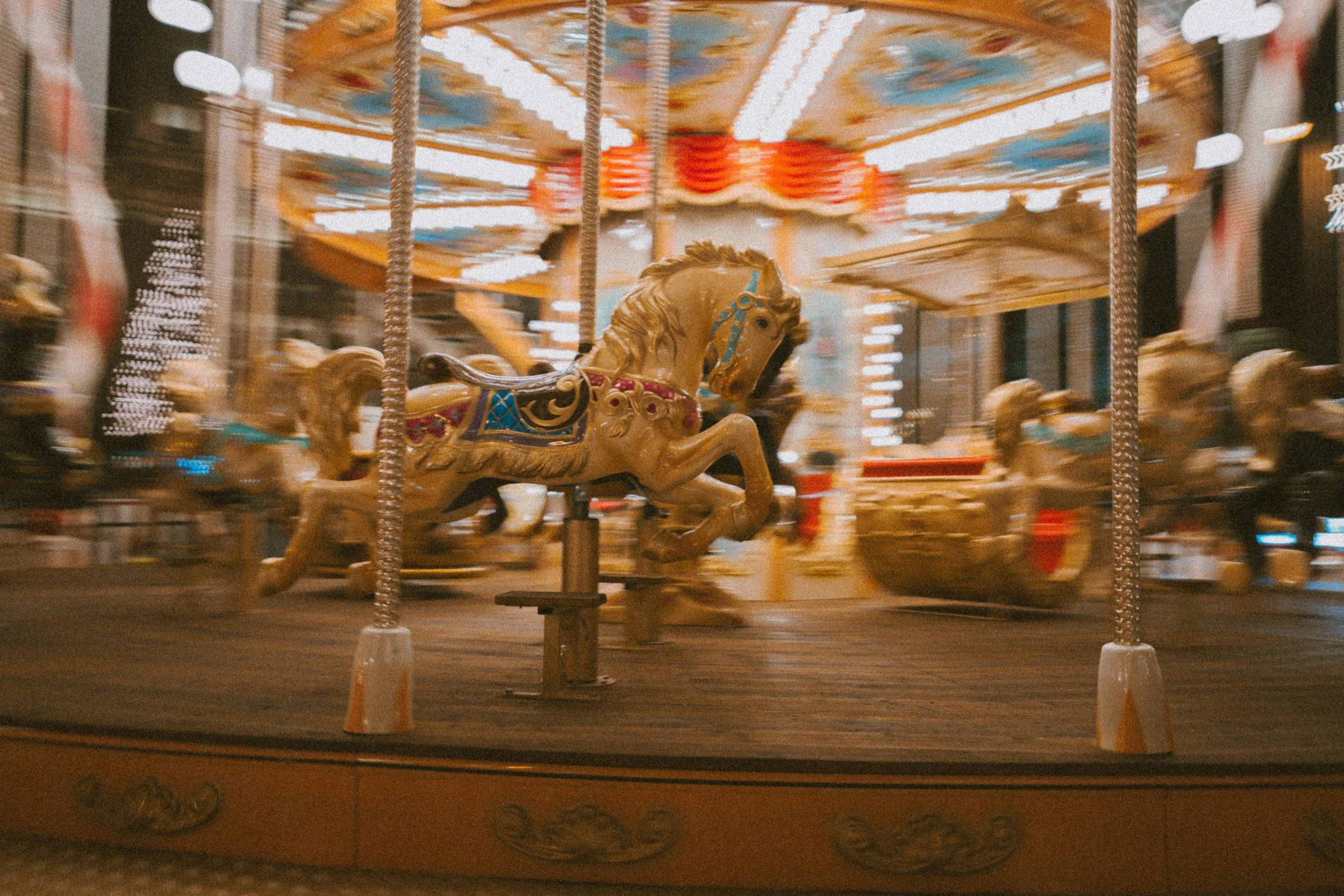 Blurred carousel in motion illustrating how chronic pain keeps the nervous system cycling through the same survival patterns despite effort to heal