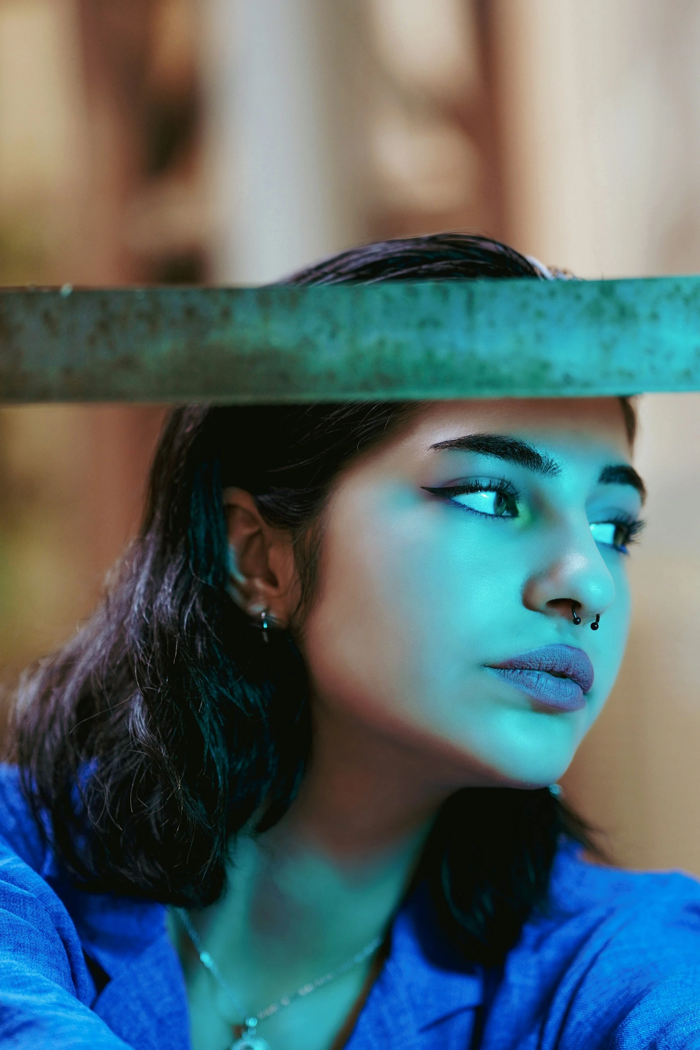 Close-up of a woman with a nose piercing and a calm, thoughtful expression, symbolizing the unseen symptoms of chronic pain and the need for emotional and sensory challenges to be taken seriously.