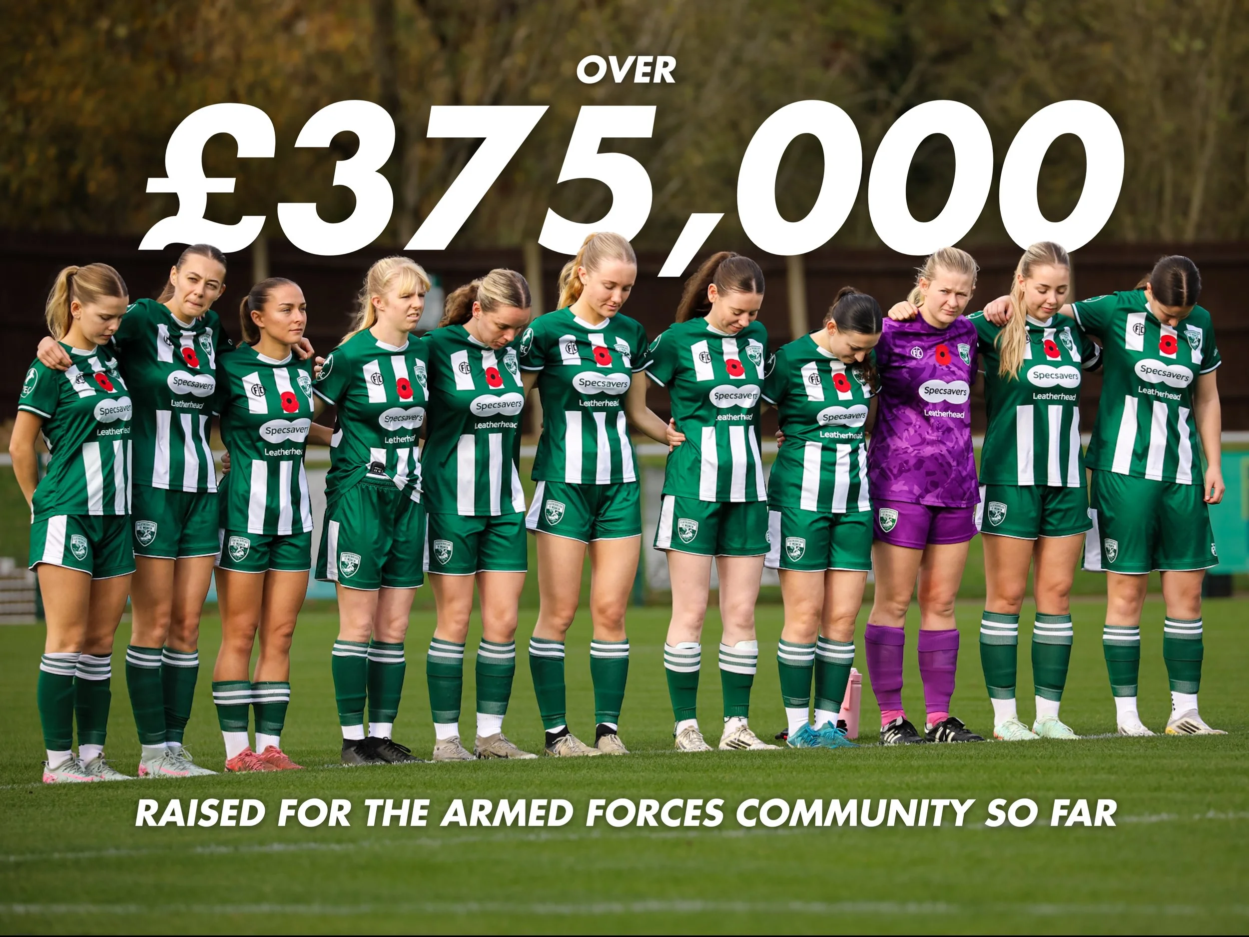 Women soccer players standing in a line on the field, with their hands on each other's shoulders, during a moment of silence, wearing green and white uniforms, one player in purple goalkeeper gloves.