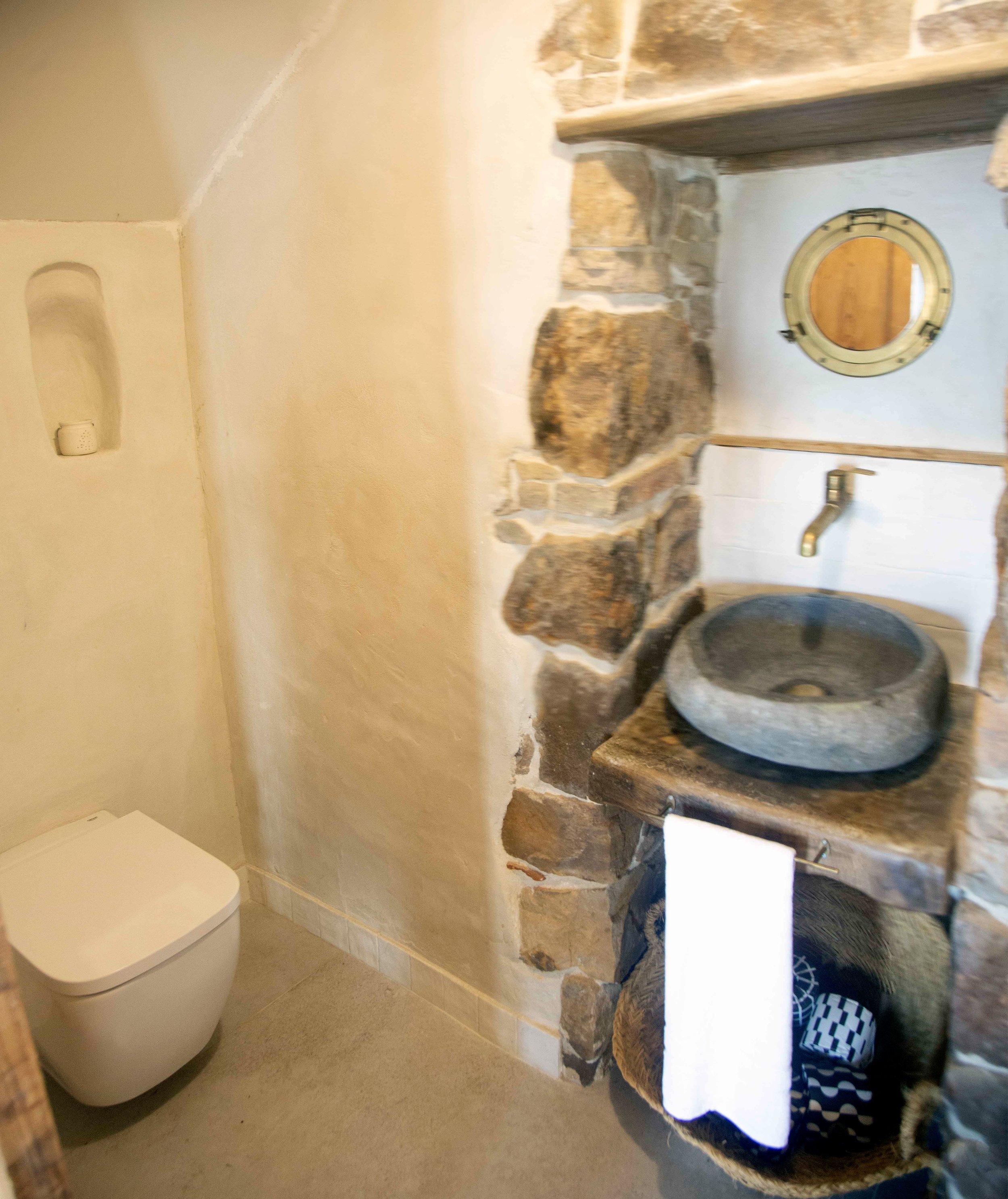 Side View Floating Toilet and Stone Basin