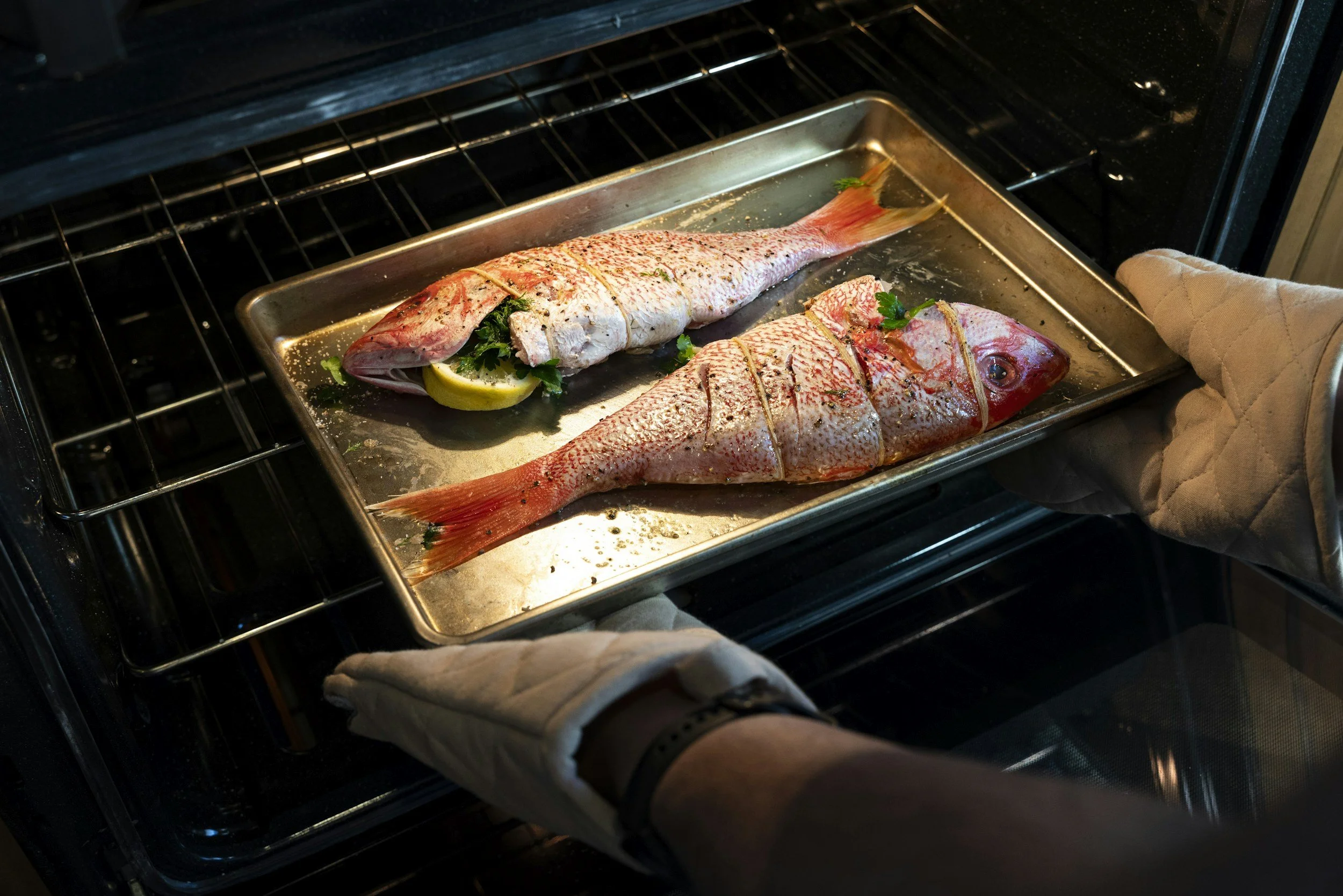 Two fish placed into the oven