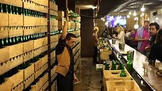 Asturian man performing traditional sidra escanciado pouring technique
