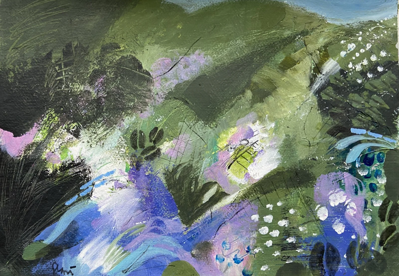 Green landscape and purple and blue at the bottom and a corner of the shy at the top