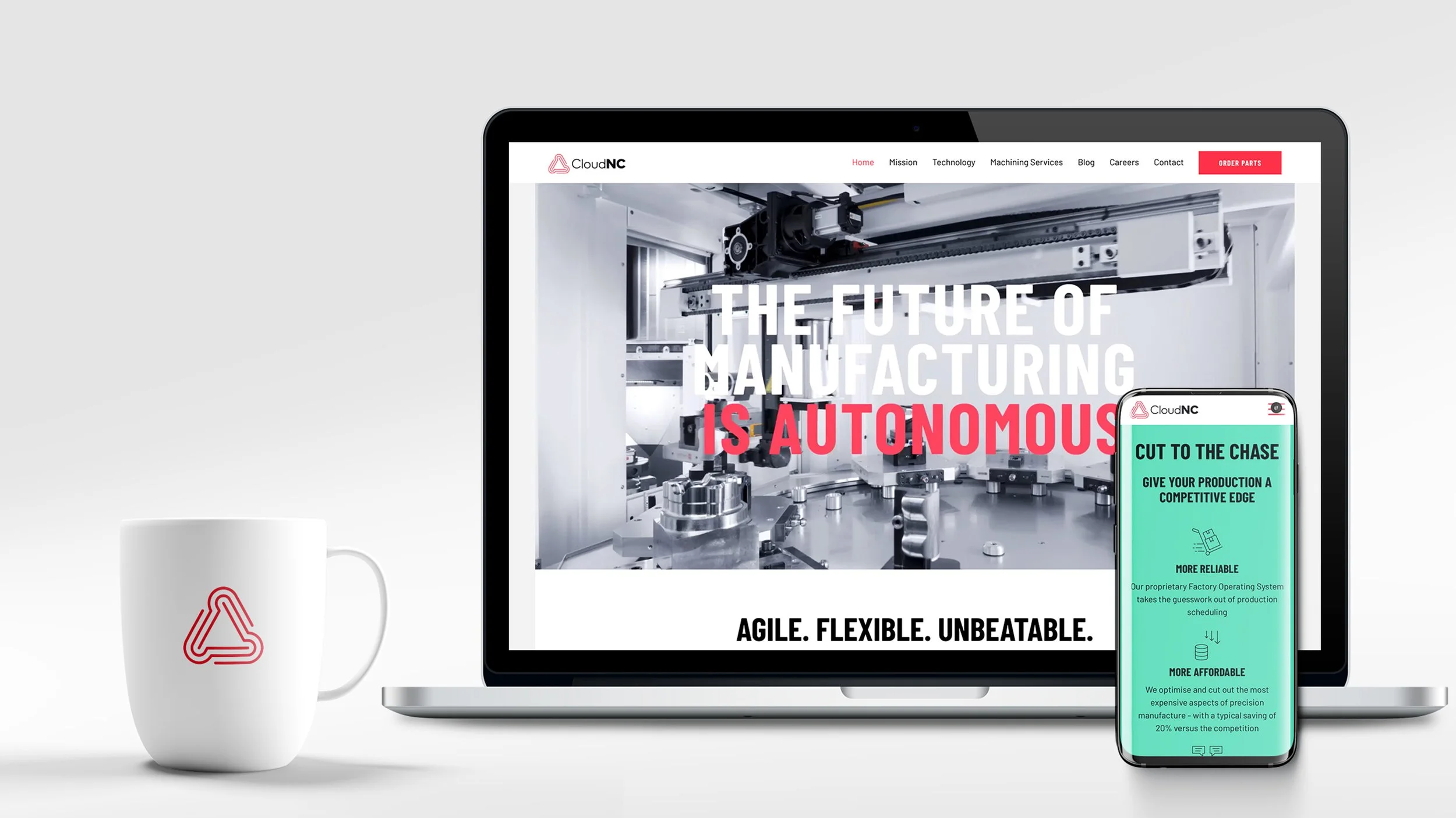 A computer and smartphone displaying a manufacturing company's website, with a white mug featuring a red logo on a white surface.