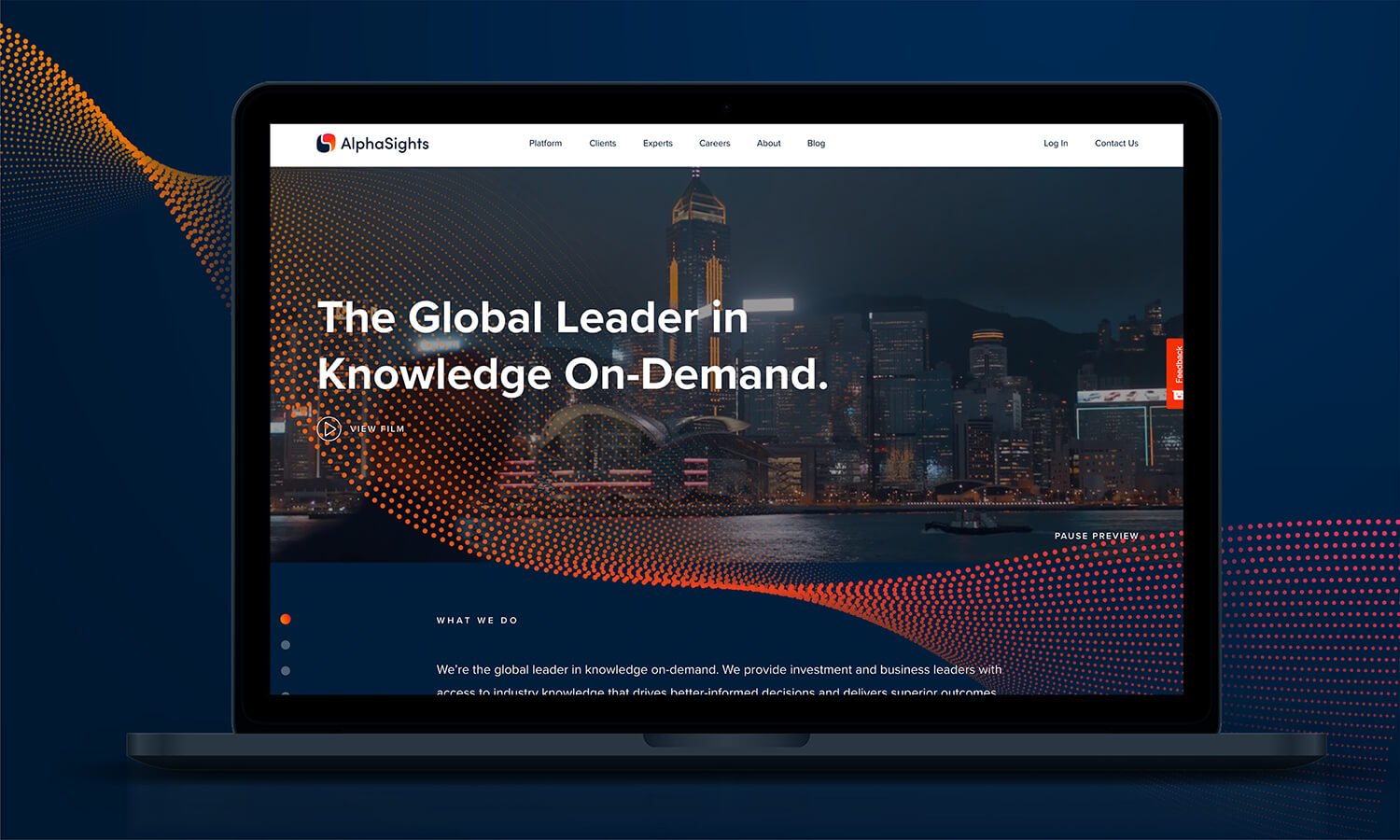 Laptop displaying a webpage for AlphaSights, with a city skyline at night in the background, featuring tall buildings and lights, with text mentioning knowledge on-demand.