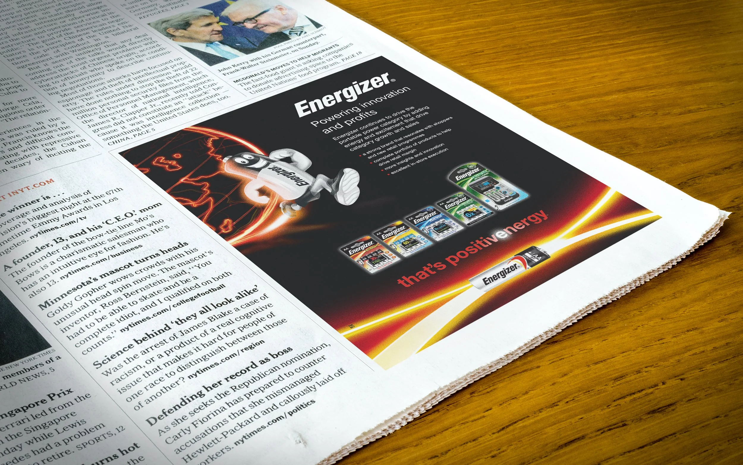 A newspaper page with an advertisement for Energizer batteries, featuring a cartoon battery character, battery images, and the slogan "that's positive energy."