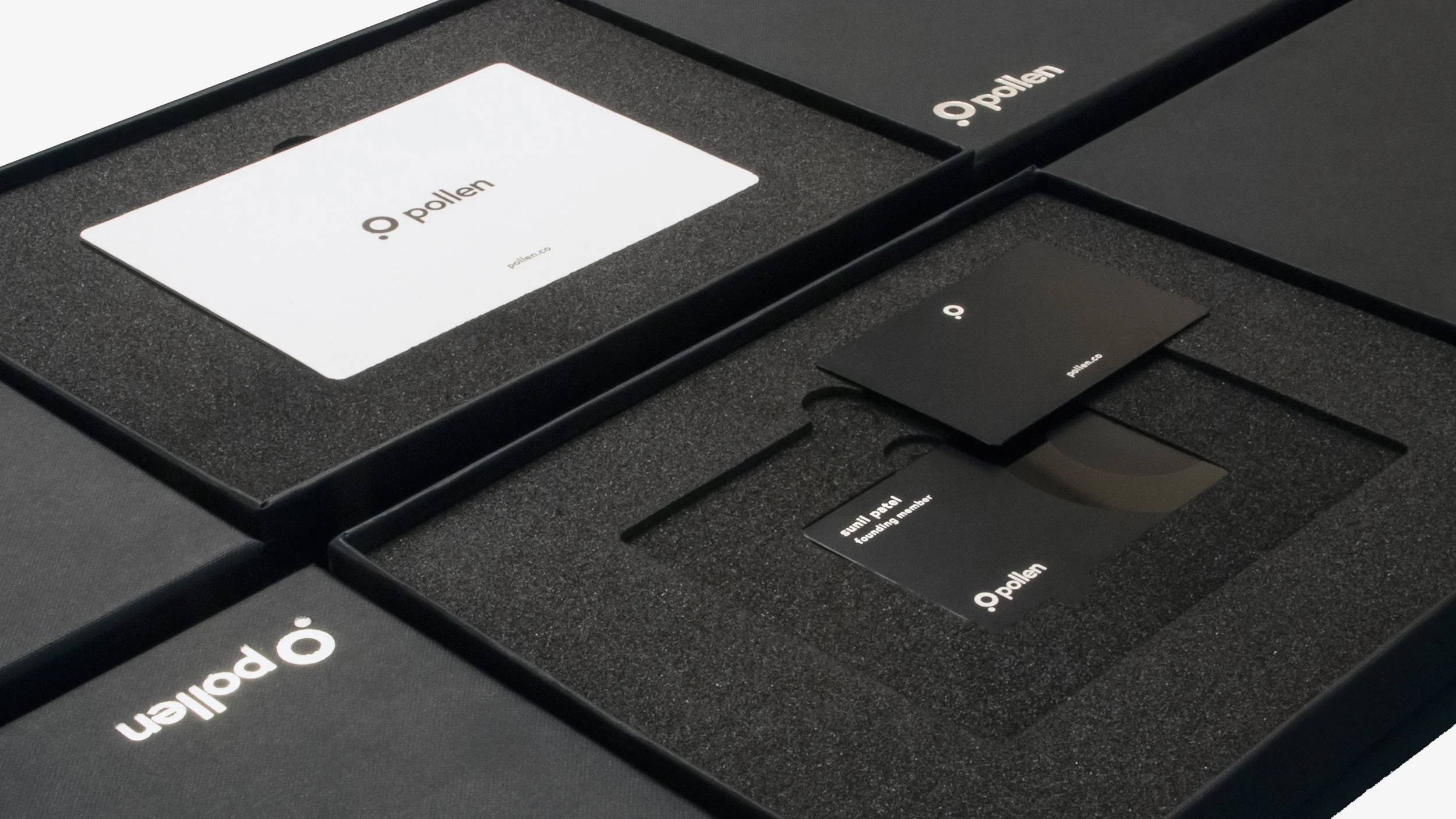 Open black box containing branded Pollen components, including a white card with Pollen logo and URL, and several black cards with Pollen logo and descriptions, arranged in foam padding.