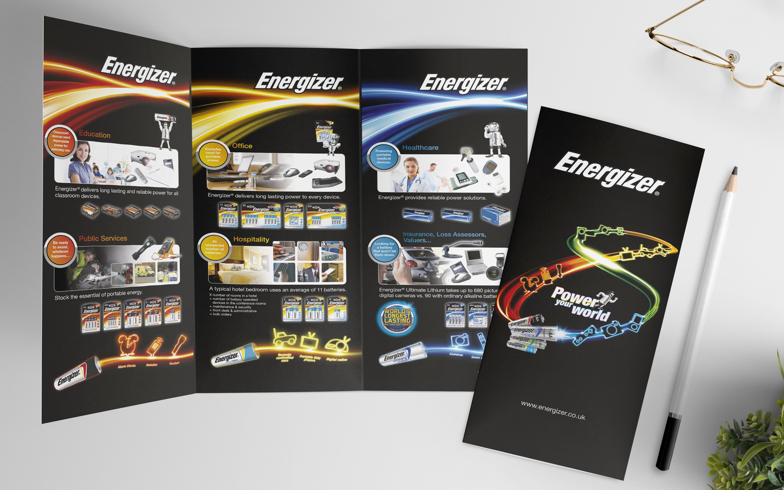 Branded Energizer promotional brochure and flyer featuring battery products for various sectors like education, office, healthcare, public services, hospitality, insurance, and more, with colorful neon-inspired graphics on a black background.
