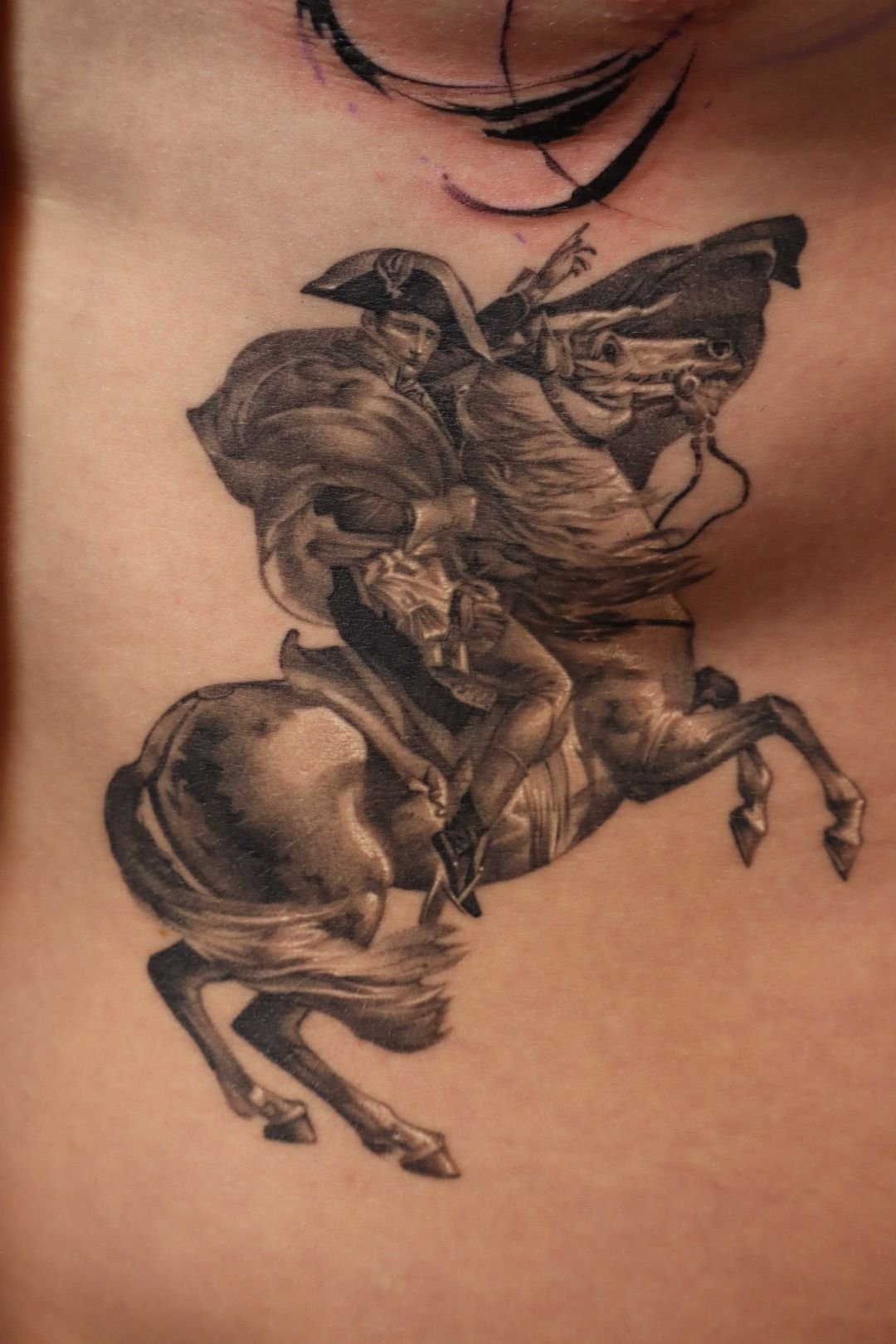 Tattoo of a historical figure on horseback, inspired by classic art.
