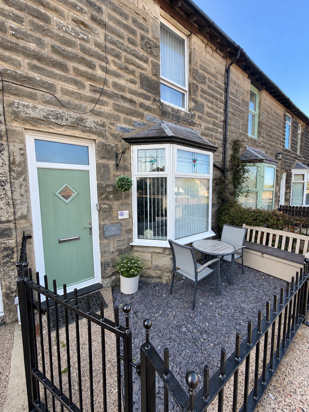 Enclosed front seating area with a bistro table and bench, perfect for enjoying a morning coffee or relaxing outdoors. A lovely little spot to unwind after exploring Seahouses and the beautiful Northumberland coast.