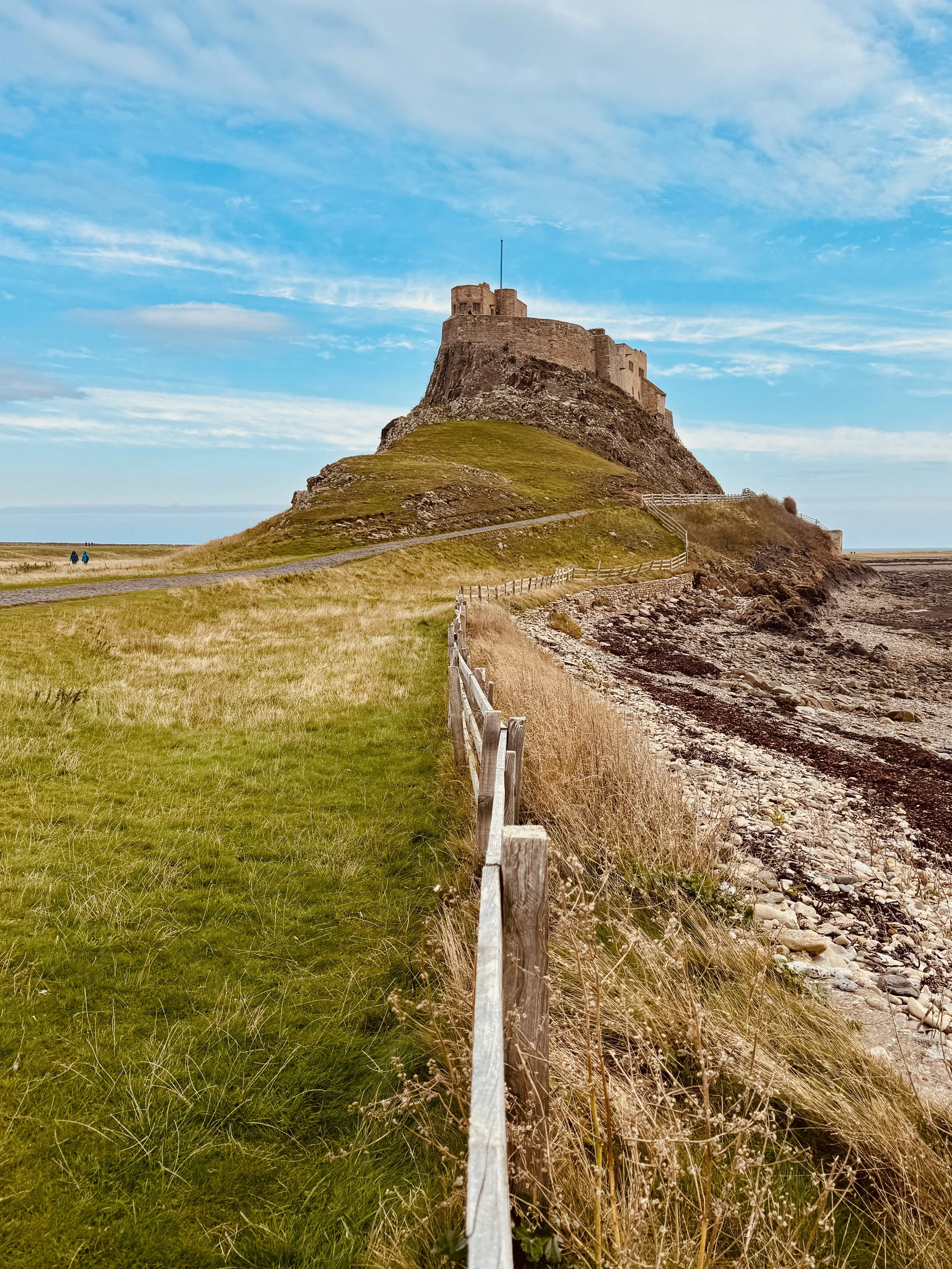 Lindisfarne Castle on Holy Island, Northumberland. Discover this iconic coastal landmark and the beautiful surroundings of the Northumberland coast during your stay at Old Stable House in Chatton.