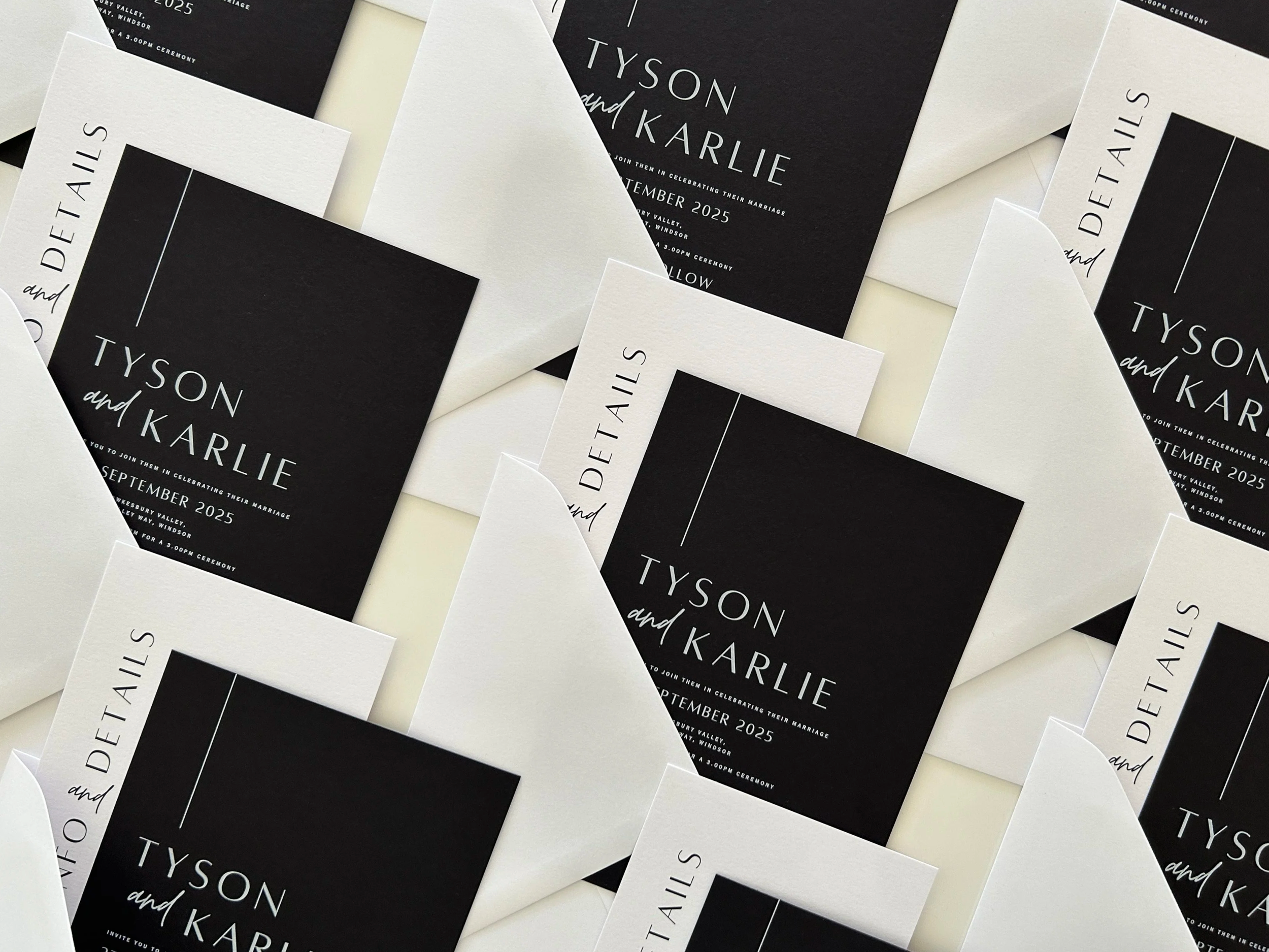 Multiple wedding invitations with black and white design scattered on a surface, containing the names 'Tyson and Karlie' and event details.