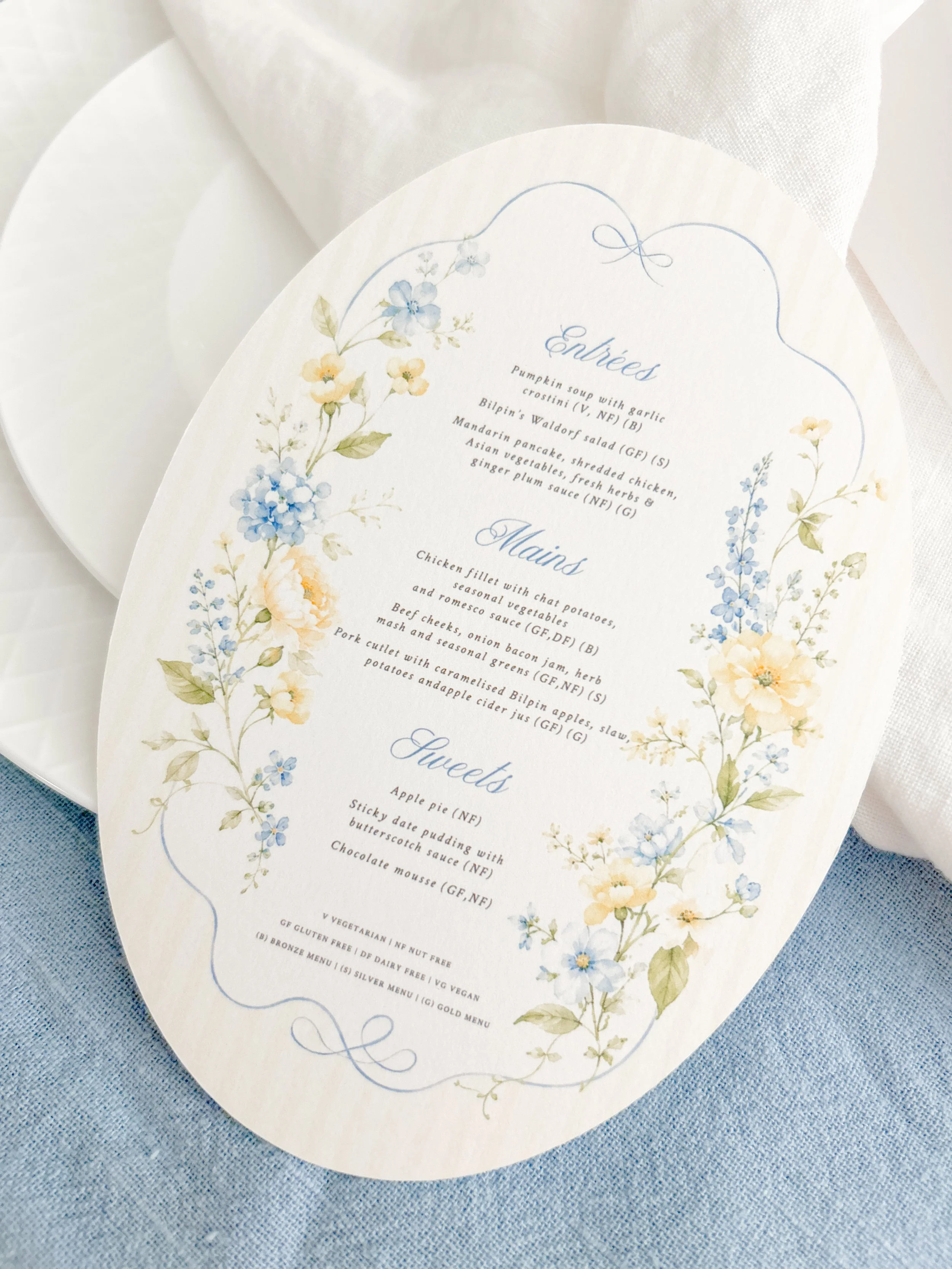 Wedding menu with floral border featuring blue and peach flowers on white background