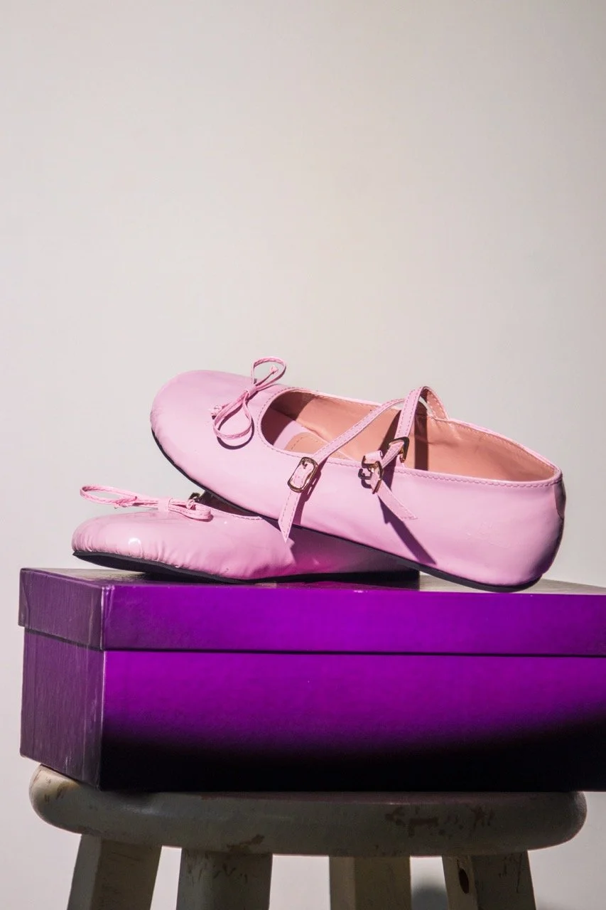 Stylish pastel pink Mary Jane flats with glossy patent leather, double straps, gold buckles, and a delicate bow – elegant and versatile women’s shoes.