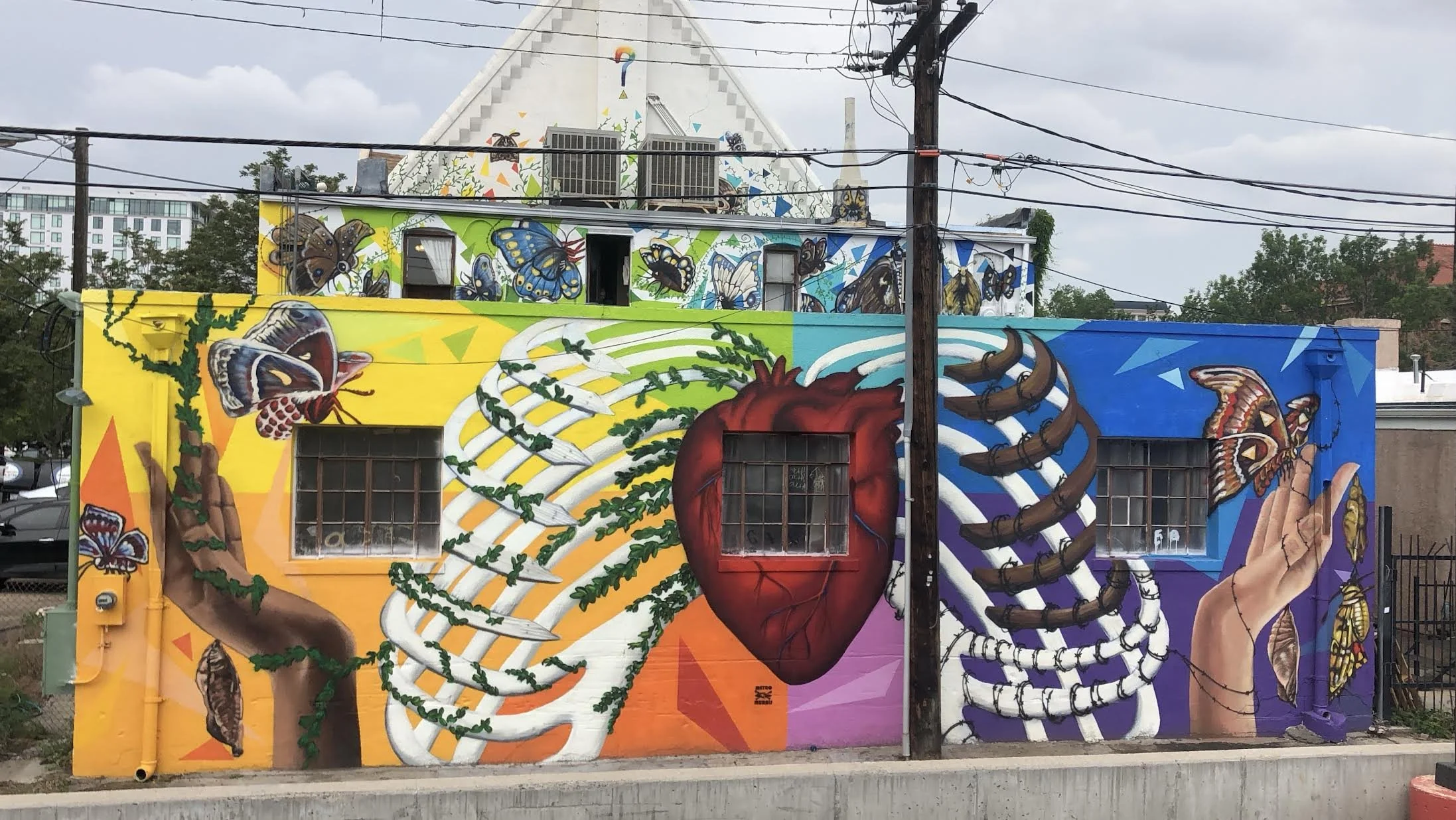 "Breaking Borders" group mural 2019 located at the Curious Theater Company