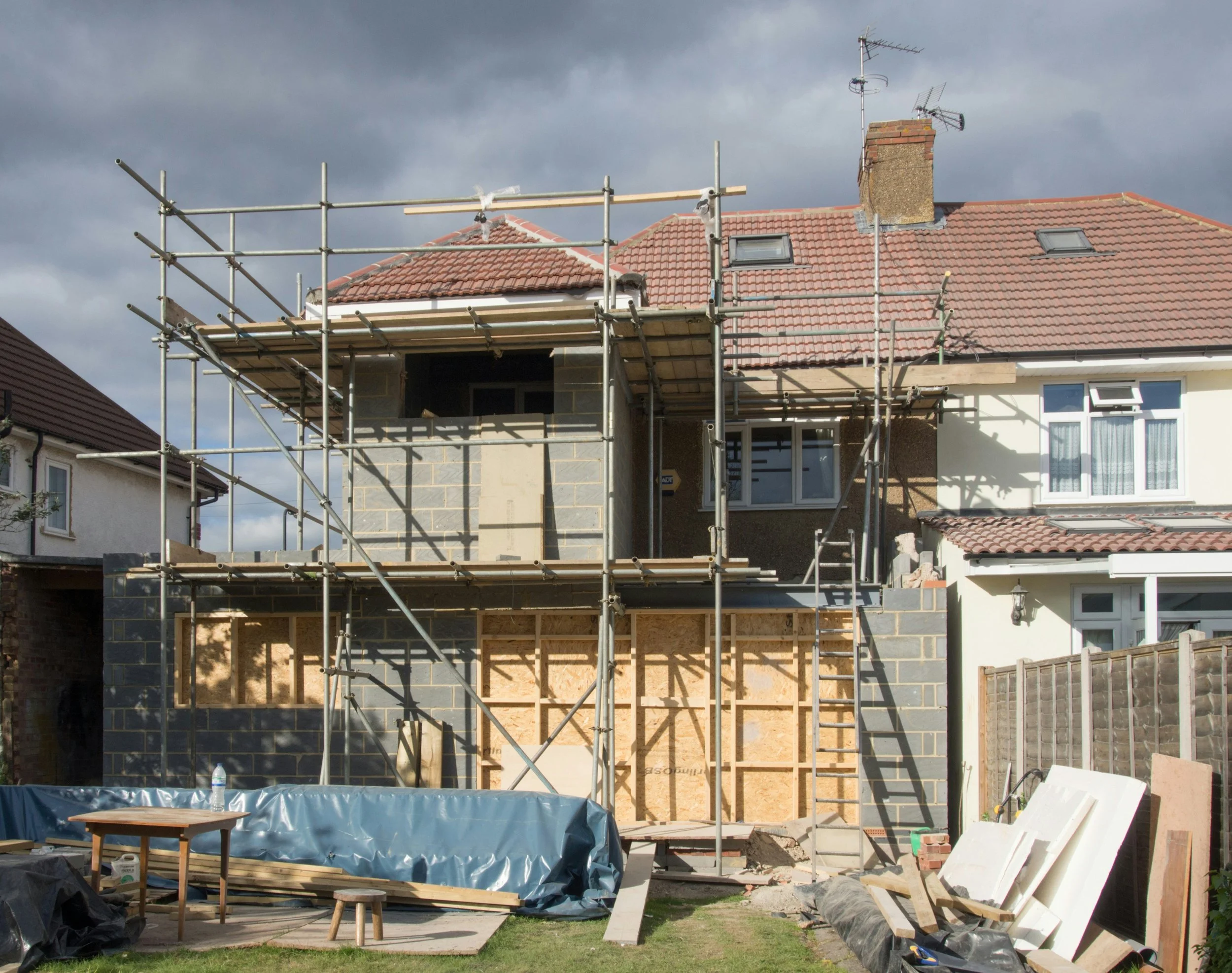 Home extension and loft conversion under construction with scaffolding.