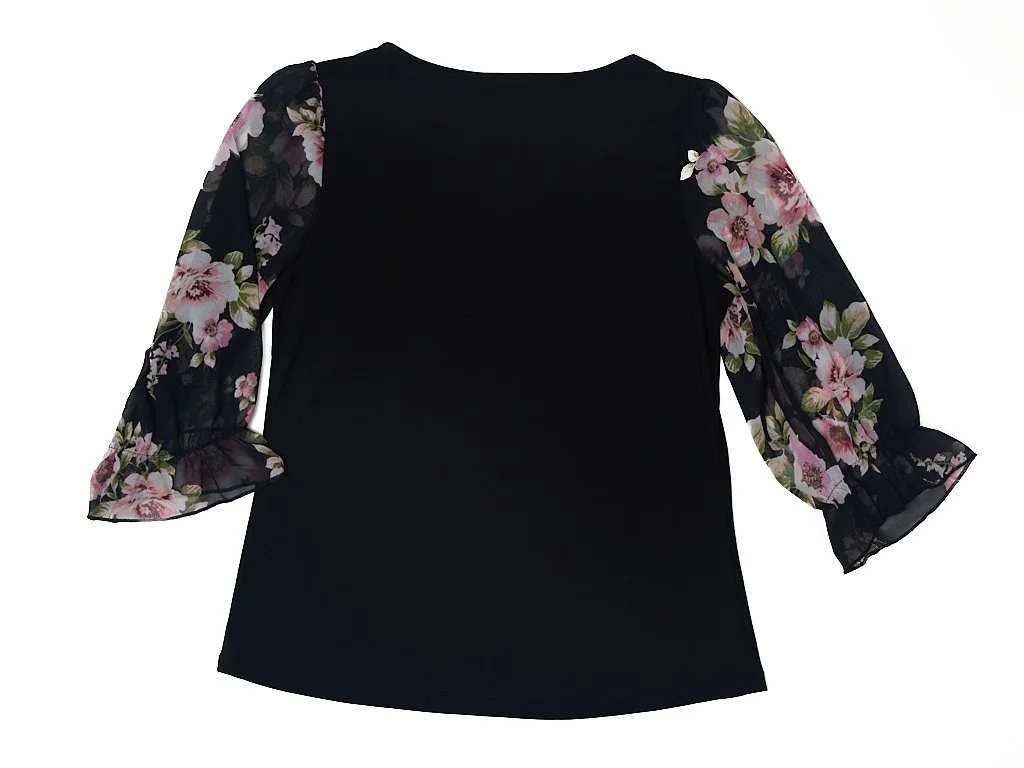 Black blouse with sheer floral print sleeves featuring pink and purple flowers.
