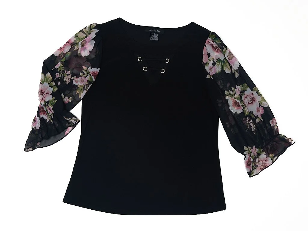 Black blouse with floral sheer puff sleeves and lace-up detail at the neckline.