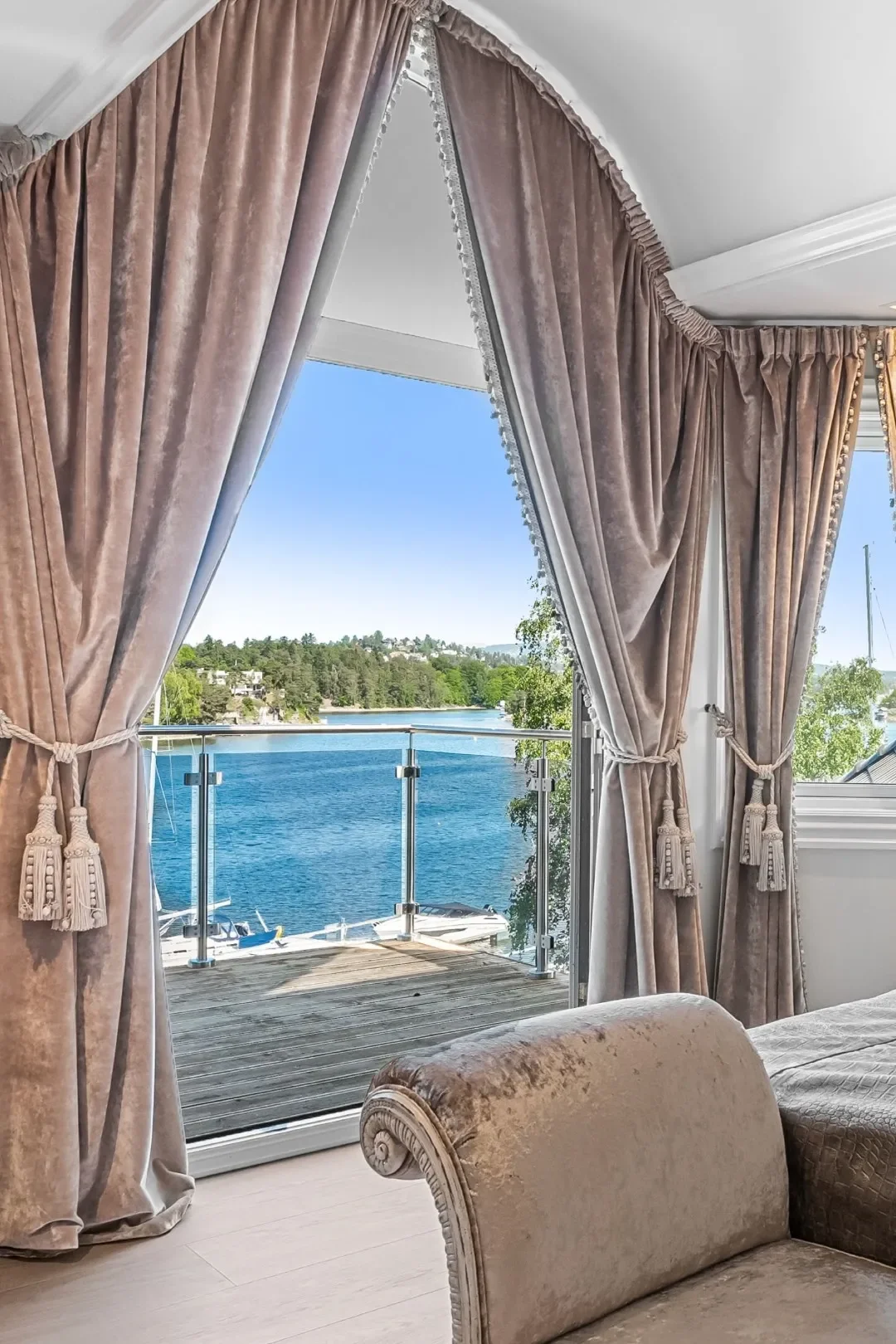 image from the upstairs balcony clad by curtains at the Oslo luxury villa for sale in Nesoya