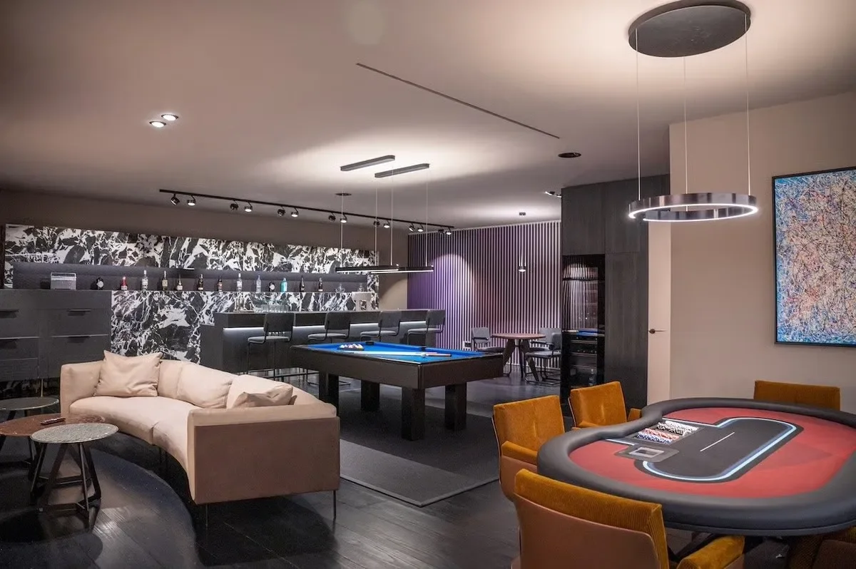 image of the games room with a poker table, pool table and more at the Cala Bassa Villa