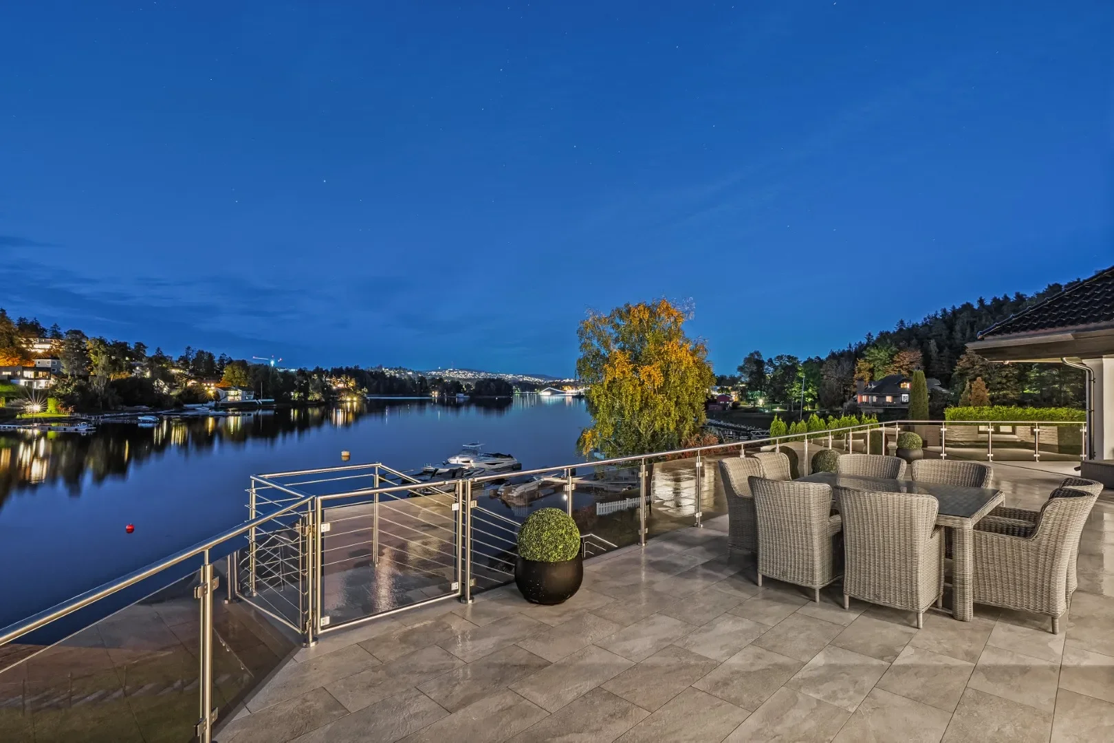 image of the lakeside view at the Oslo luxury villa for sale on a night