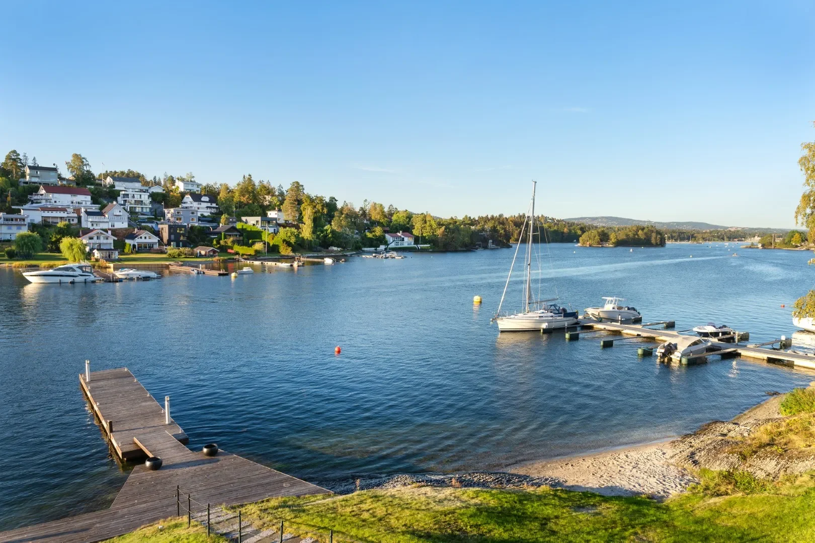 image of the pier on the lake at the luxury villa for sale in Oslo