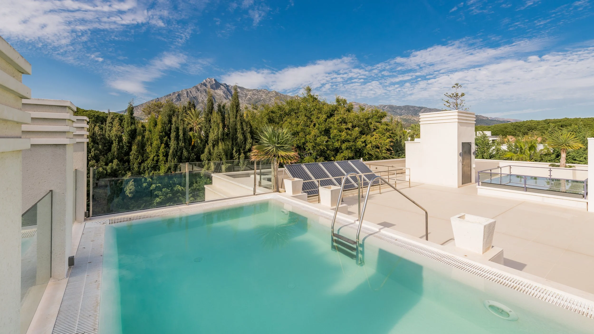 image of the rooftop pool with mountain view in background of marbella luxury villa