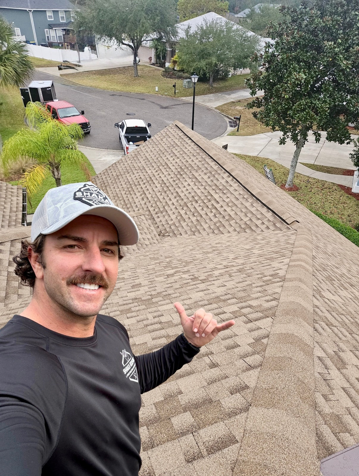 Shaka Roofing owner Sean taking a selfy showing off a shingle roof replacement done on a residential home in oceanway jacksonville