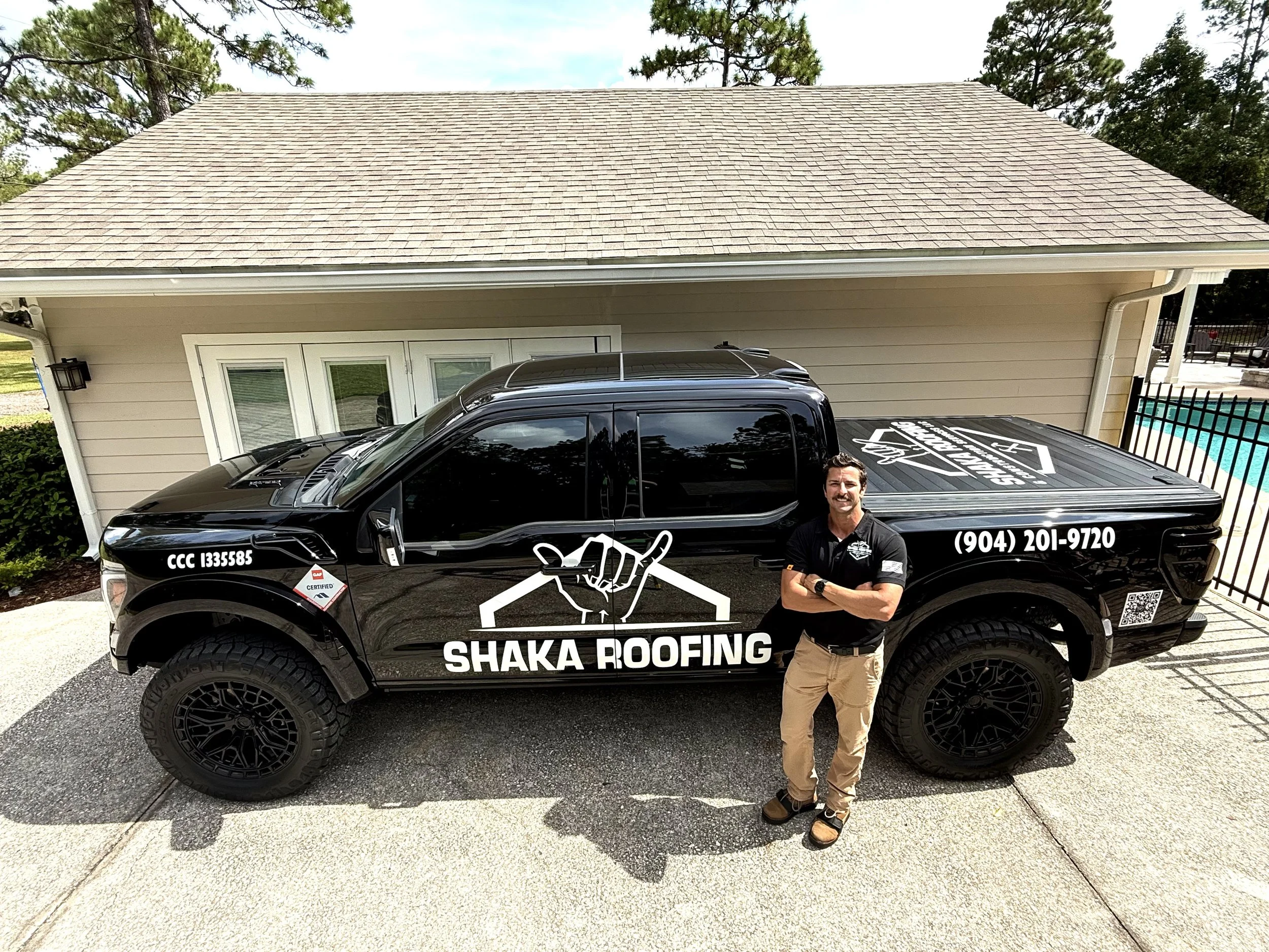 Sean Nicholson standing in front of a truck with a Shaka Roofing wrap
