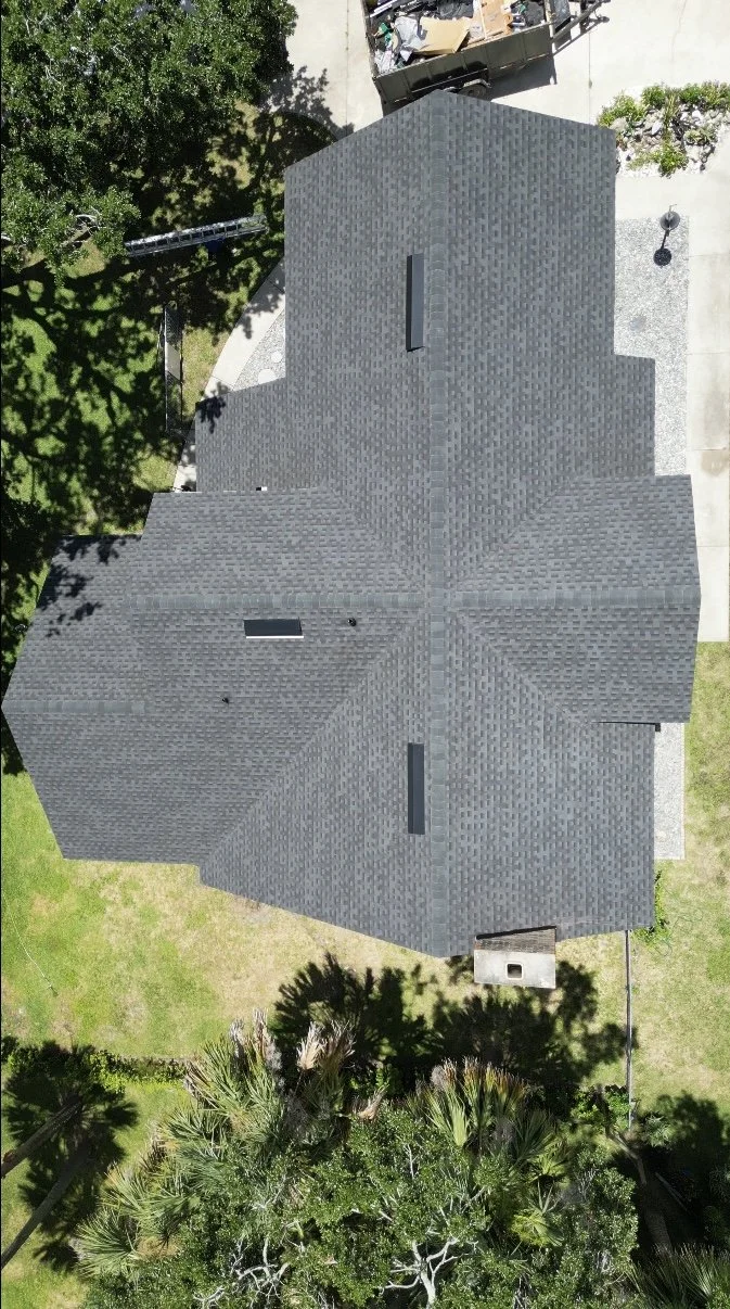 Aerial view of a roof replacement with GAF architectural shingles, color: charcoal. 