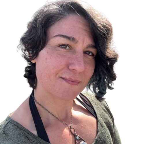 Woman with short wavy dark hair, fair skin, and wearing a green shirt and a necklace.