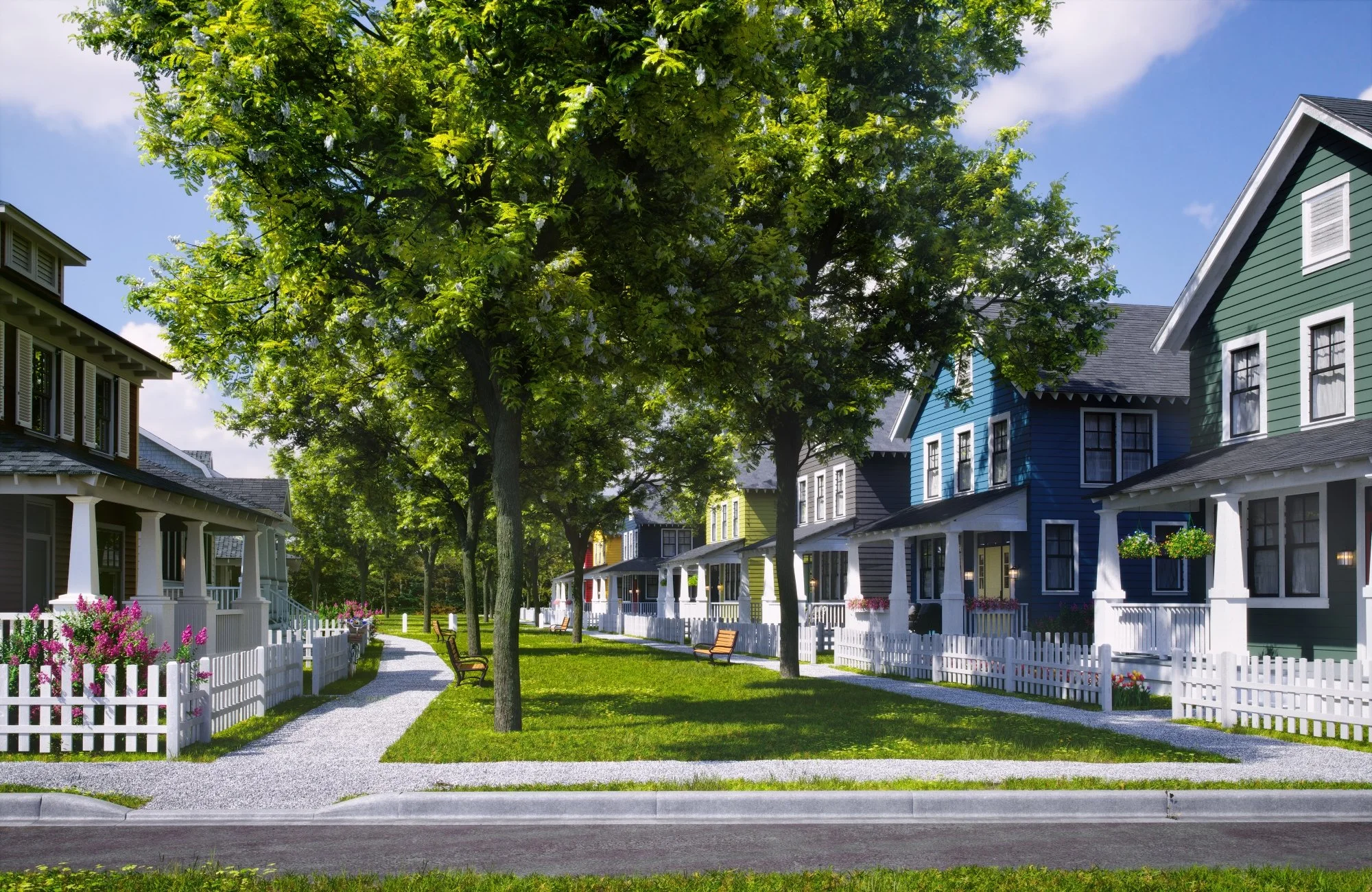 Colorful houses on a residential street with a green lawn, trees, and a gravel walking path.