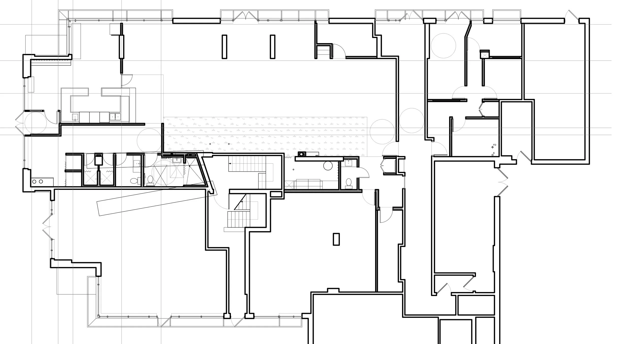 Architectural floor plan of a building with multiple rooms, hallways, stairs, and doors, drawn in black and white.