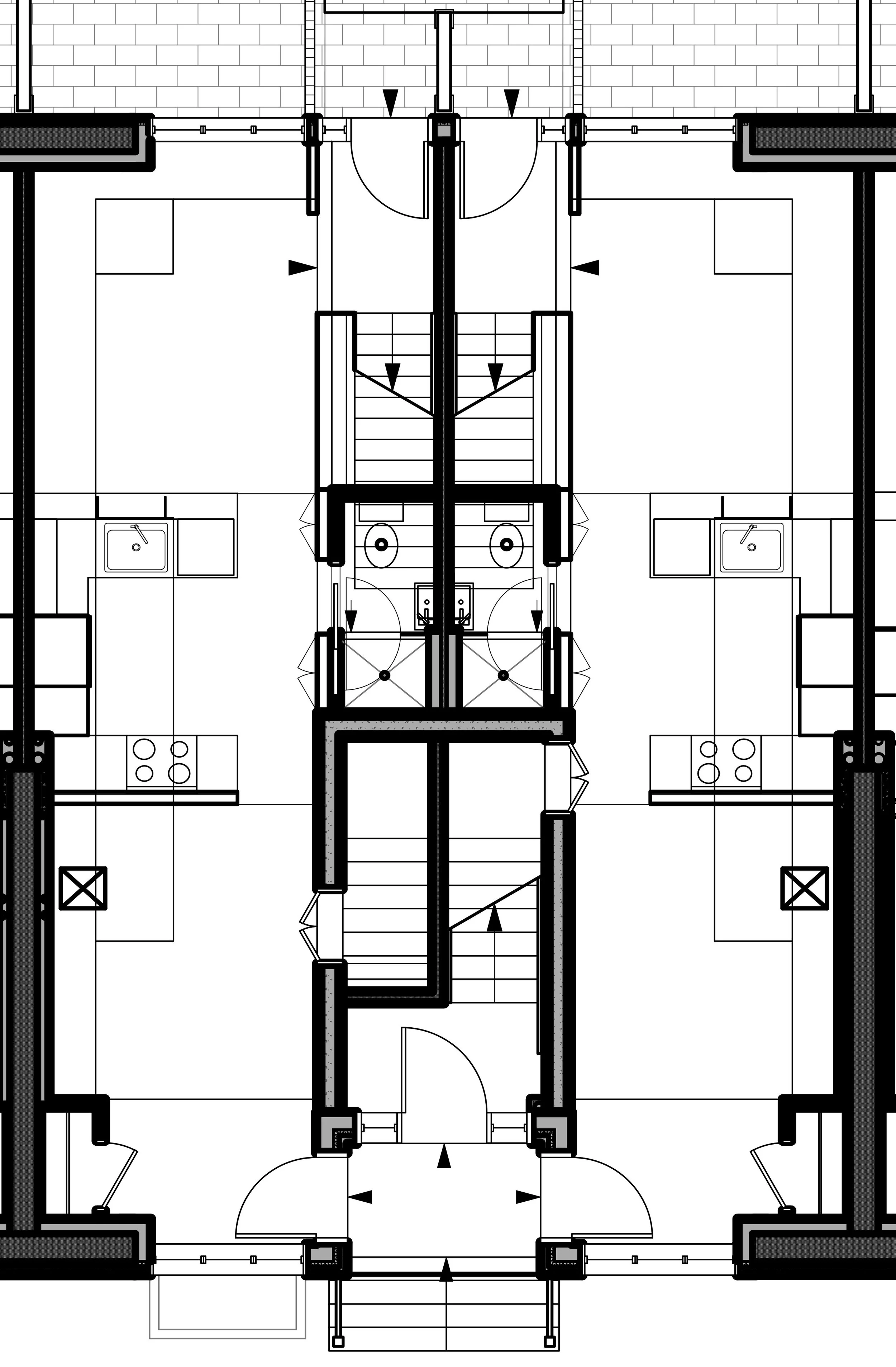 Architectural blueprint of a building's floor plan showing staircases, bathrooms, and kitchen areas.