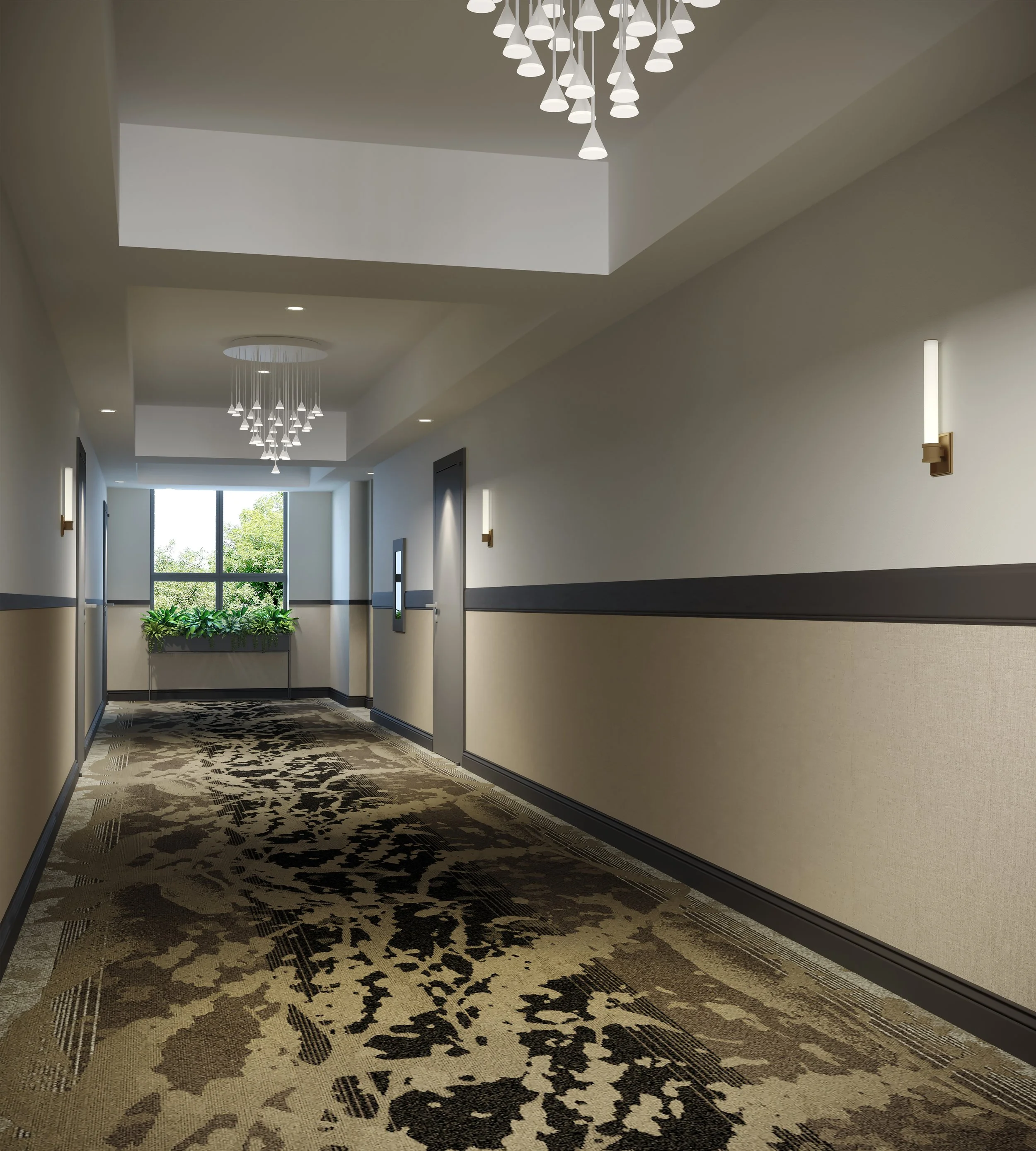 Empty hotel hallway with beige and gray walls, modern light fixtures, and a patterned carpet, leading to a window with green plants outside.
