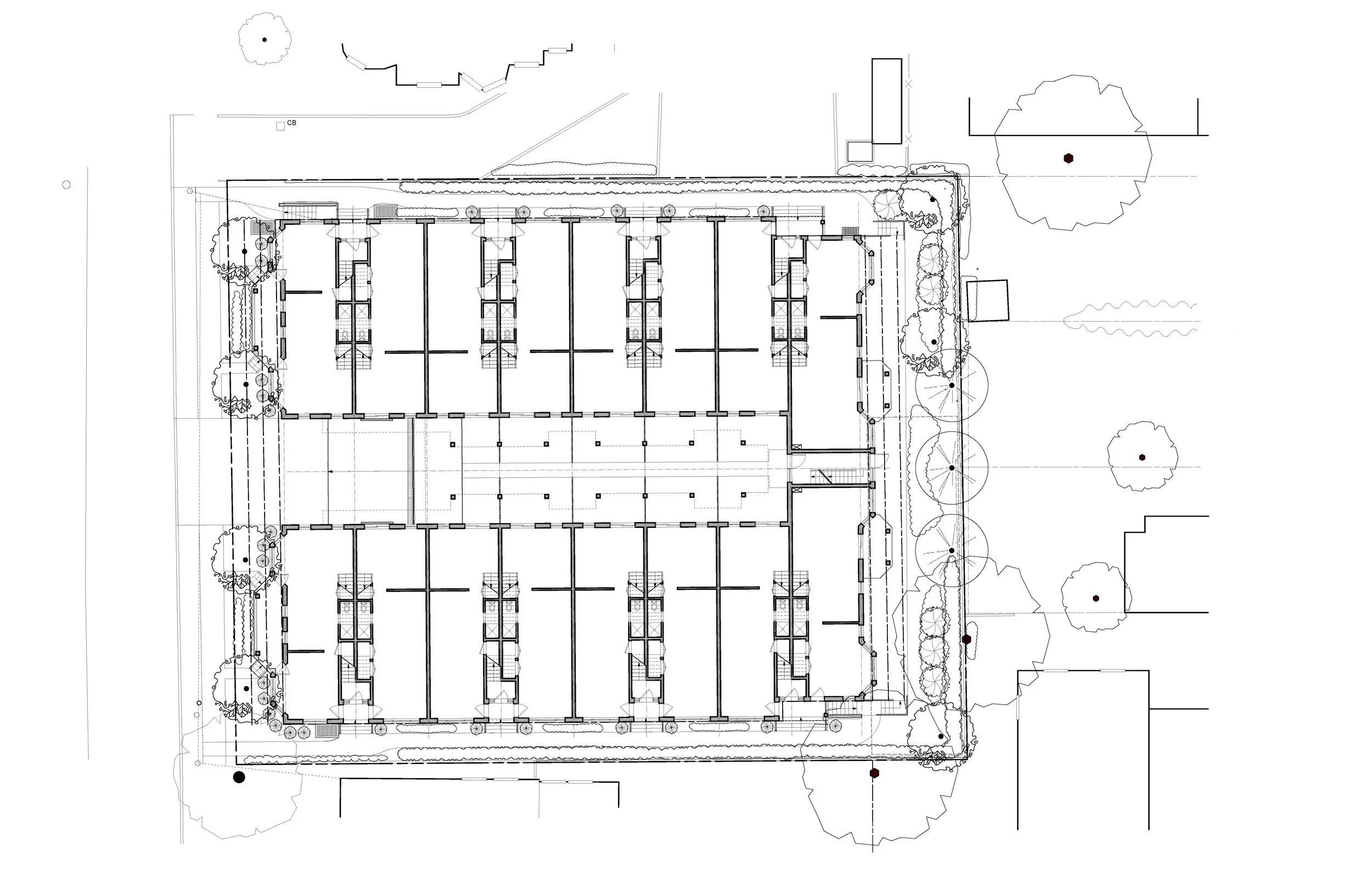 Architectural floor plan of a building surrounded by landscape with trees and pathways.