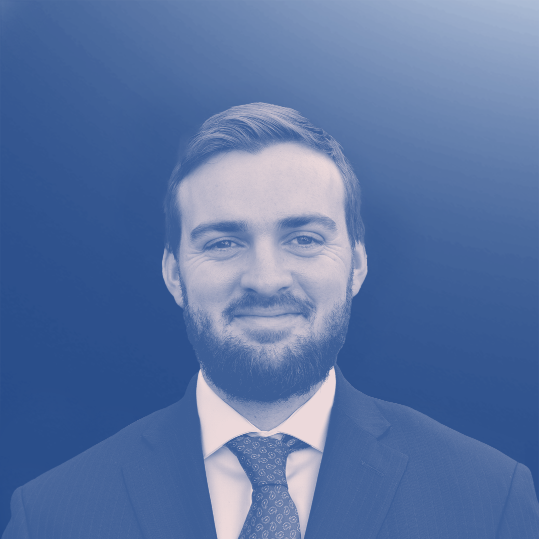 Man with a beard and suit smiling, blue tint effect