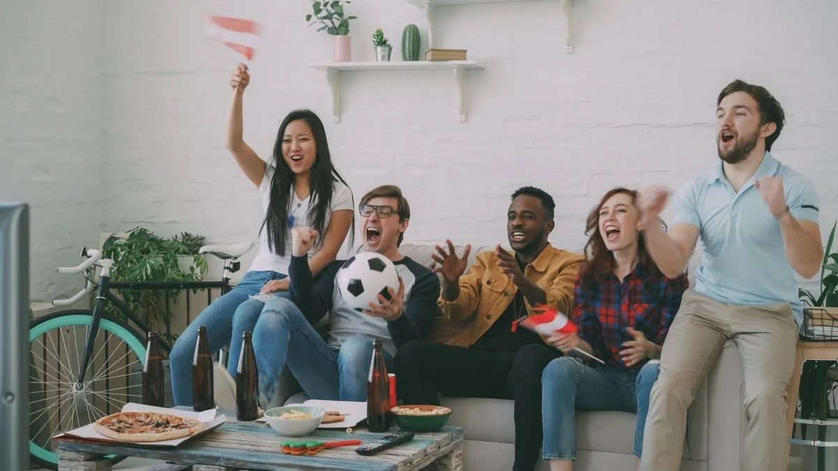 Friends cheering while watching a game
